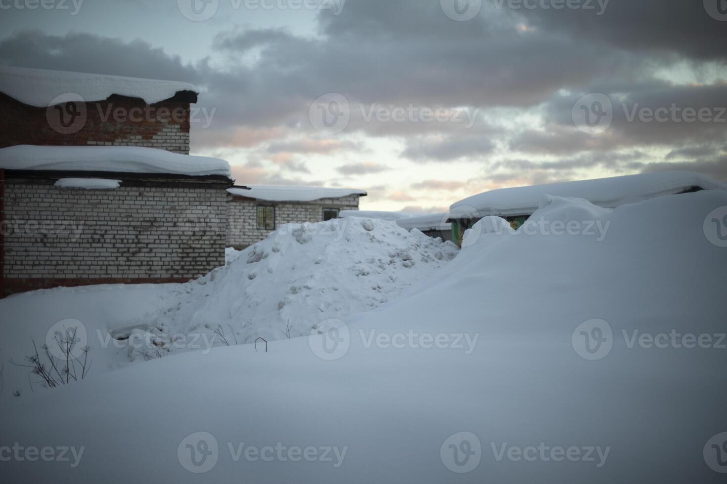 Snow heap in Narazh. A large snowdrift. Garages in winter. photo