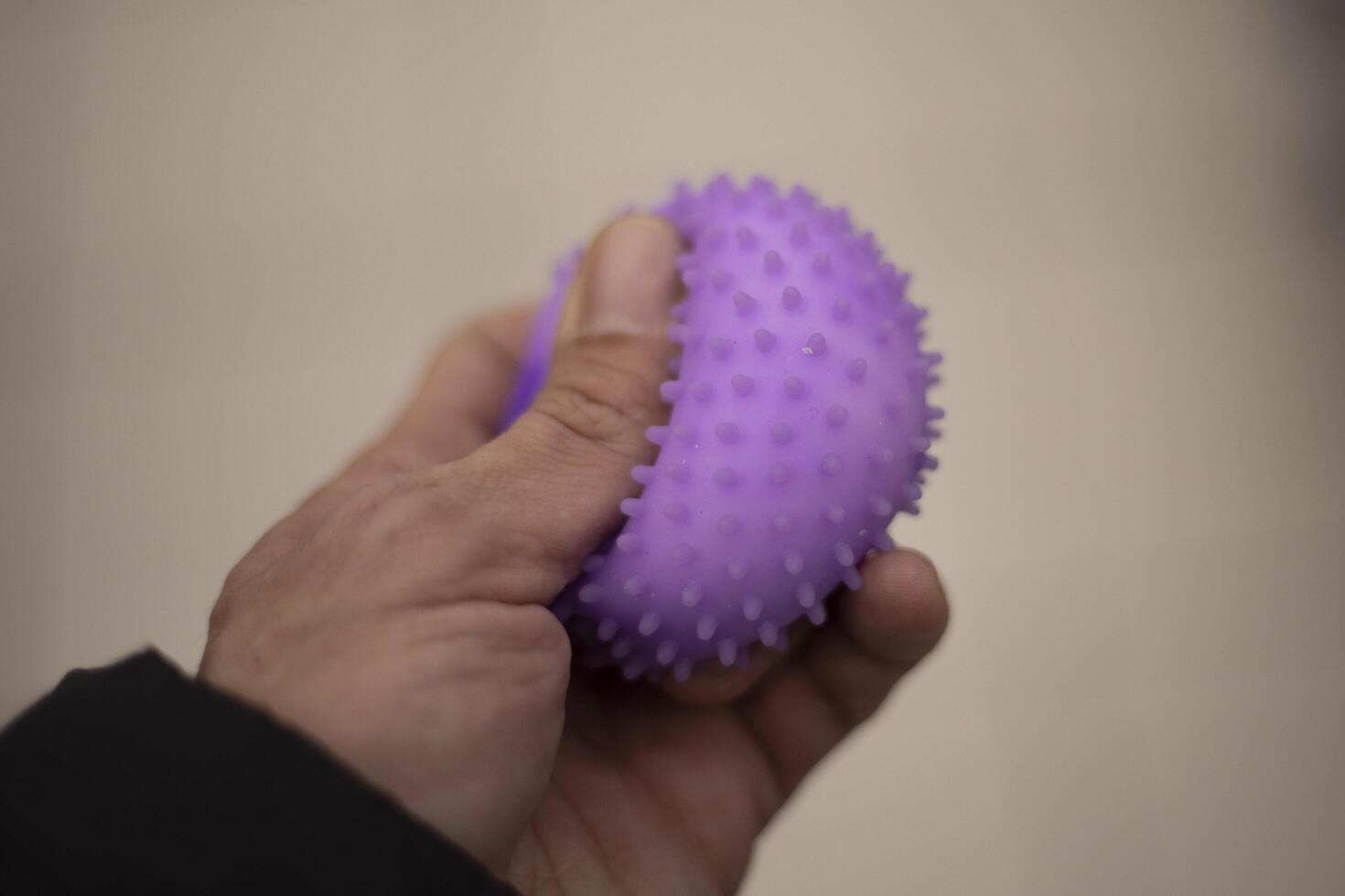Rubber toy in hand. Anti-stress toy. Children's item. photo
