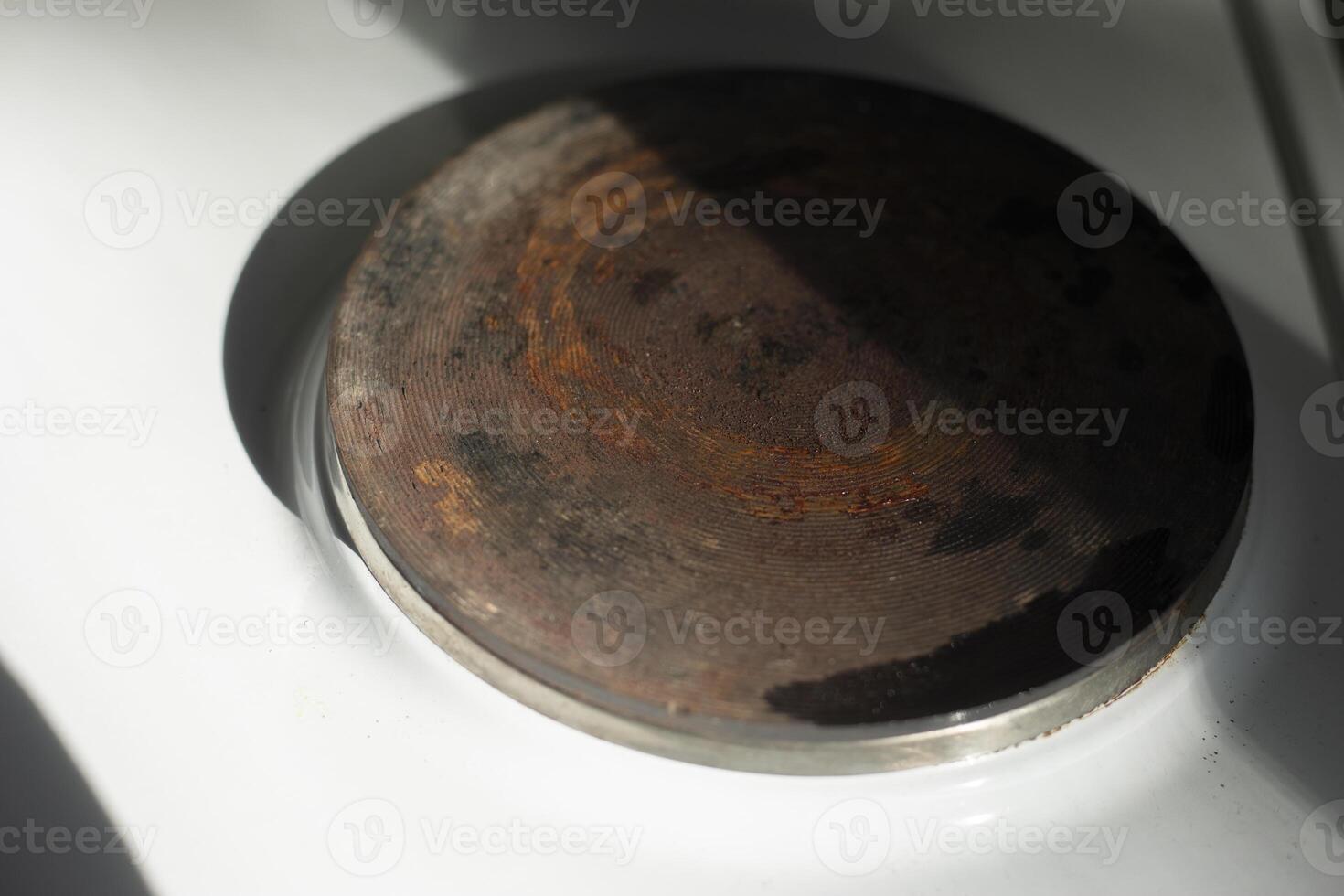 Electric stove in the kitchen. Old Electric Stove. Rust on steel. photo