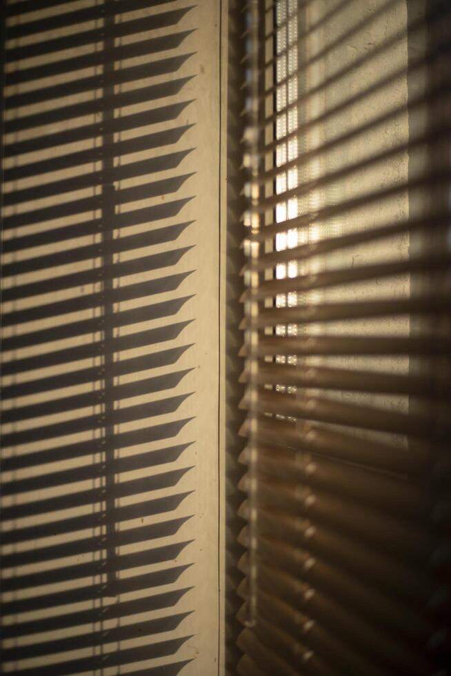 Blinds on the window. Light through the blinds. Window in the morning. photo