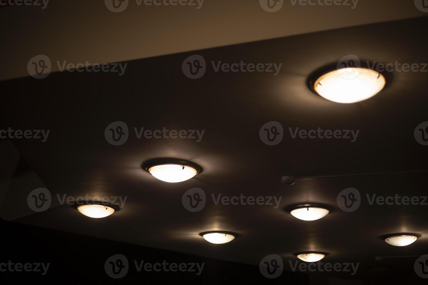 Round lamps on the ceiling. Lots of lamps in a row. Ceiling in the Great Hall. photo