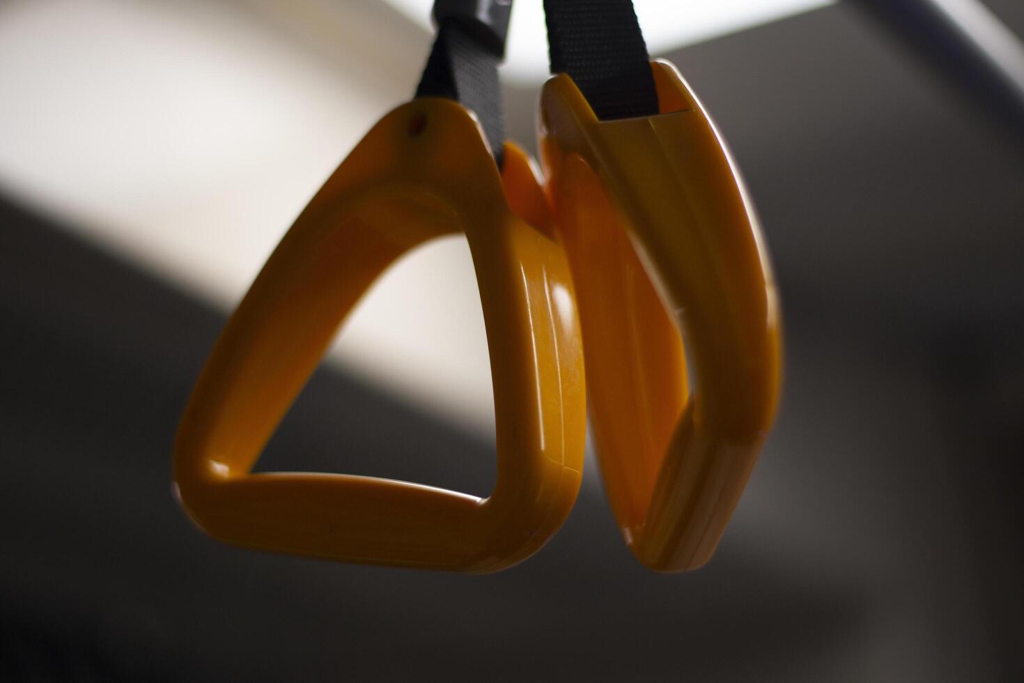 Handrail in the bus. Handrail for the hand in transport. Yellow handle on the belt. photo