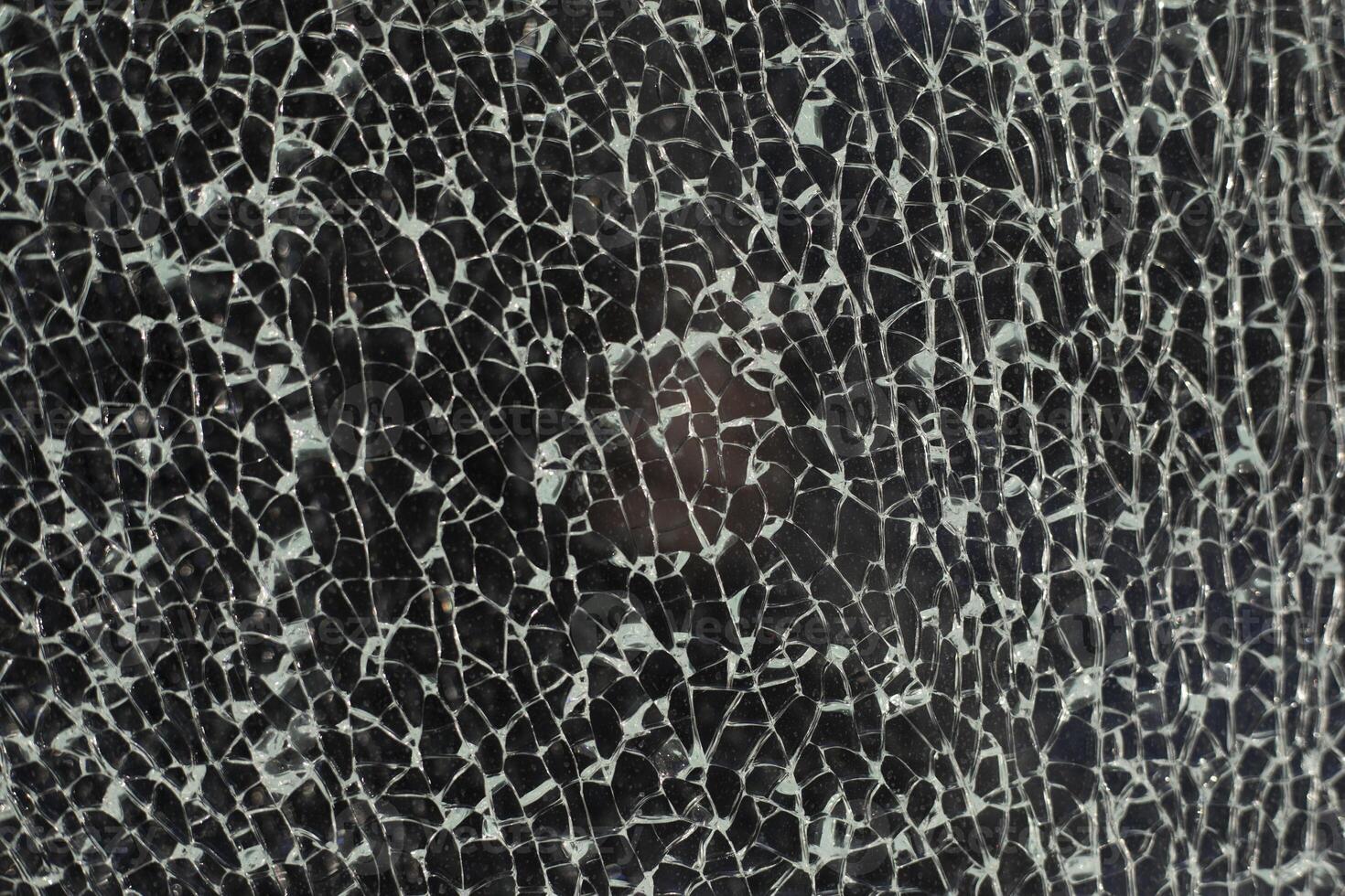 Broken glass. Cracks on the window. Small fragments. photo