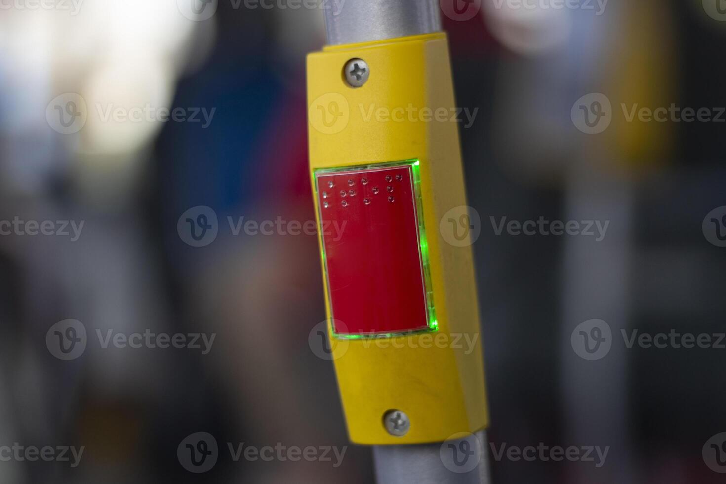Stop button on the handrail on the bus. Signal button in transport. Emergency braking. photo