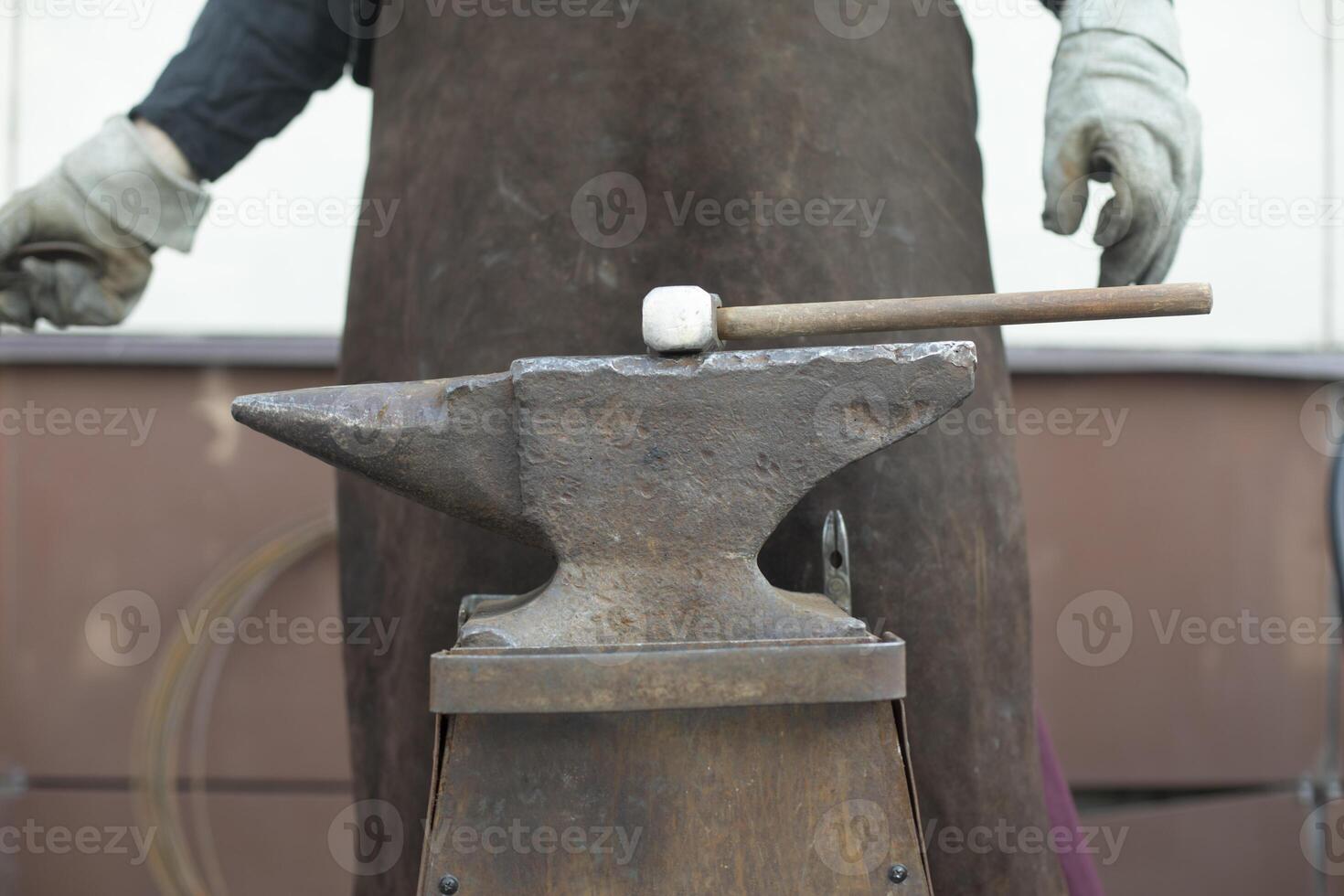 Blacksmith and Anvil. Hammer blow. Anvil on farm. photo