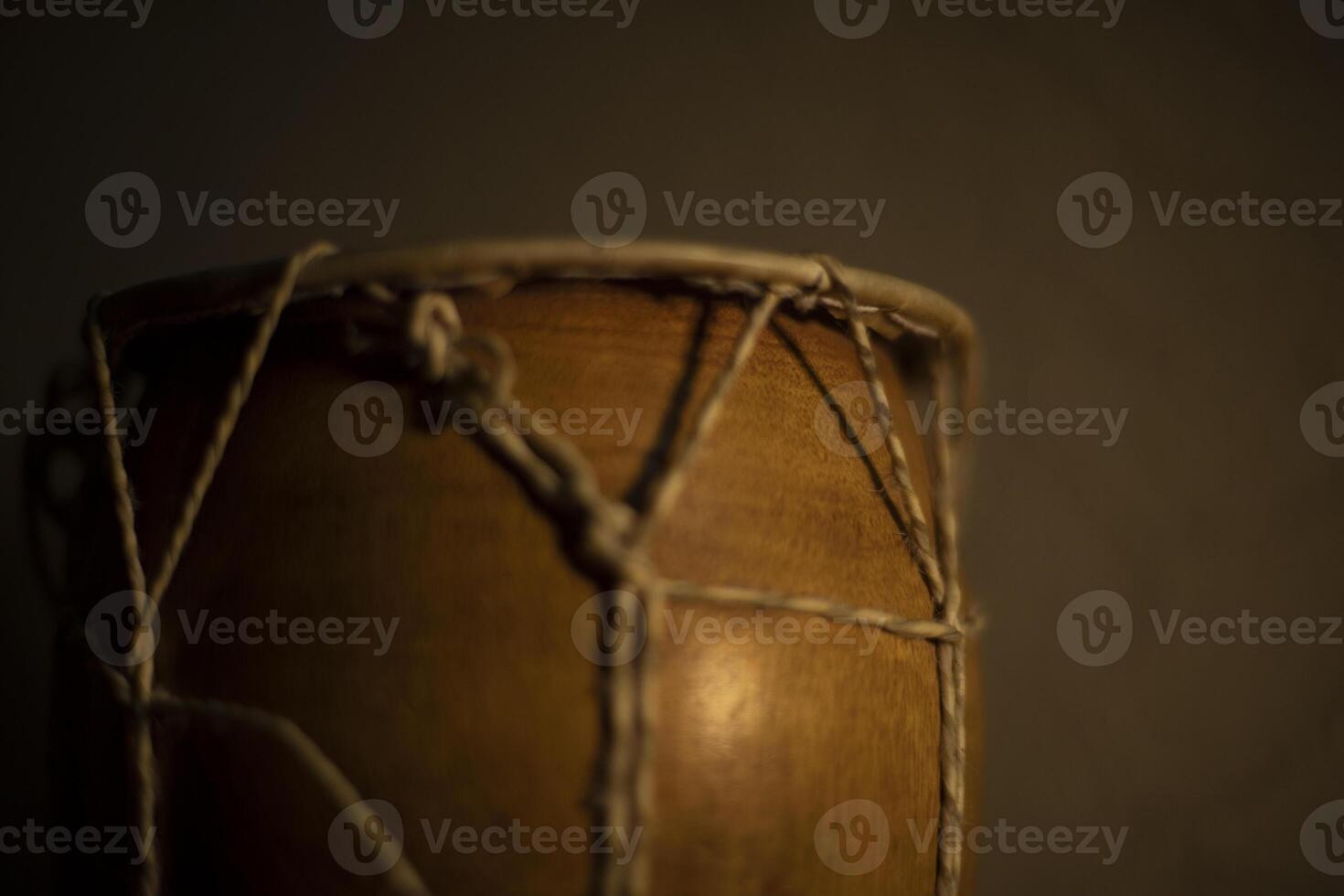 African drum. Percussion instrument made of wood. Ropes tighten membrane of drum. photo