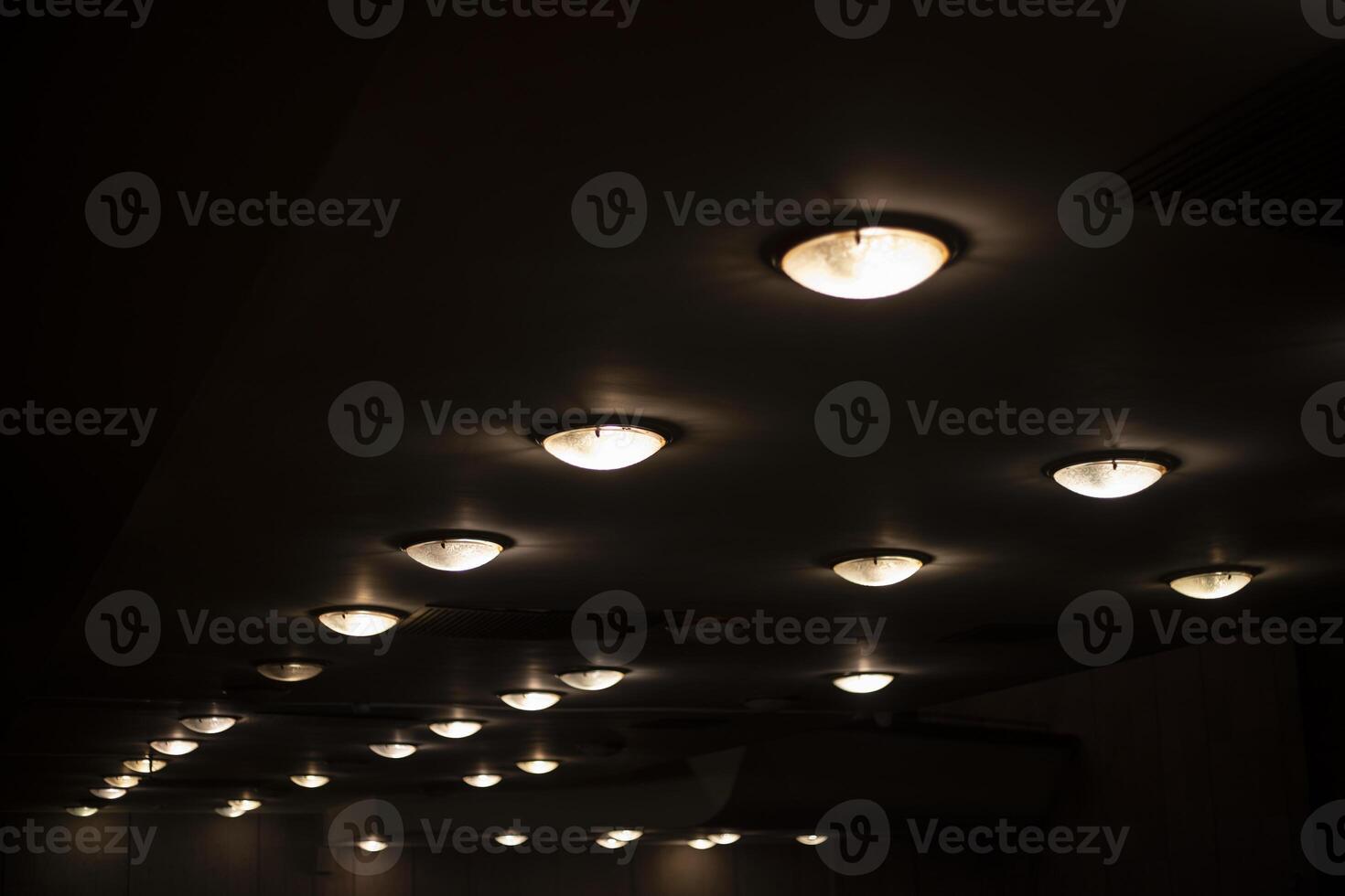 Round lamps on the ceiling. Lots of lamps in a row. Ceiling in the Great Hall. photo