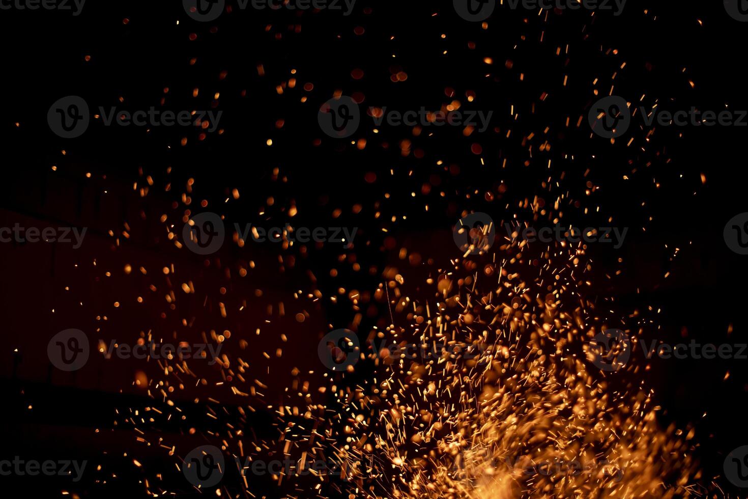 The texture of the fire. Sparks in the dark. Flames on a black background. photo