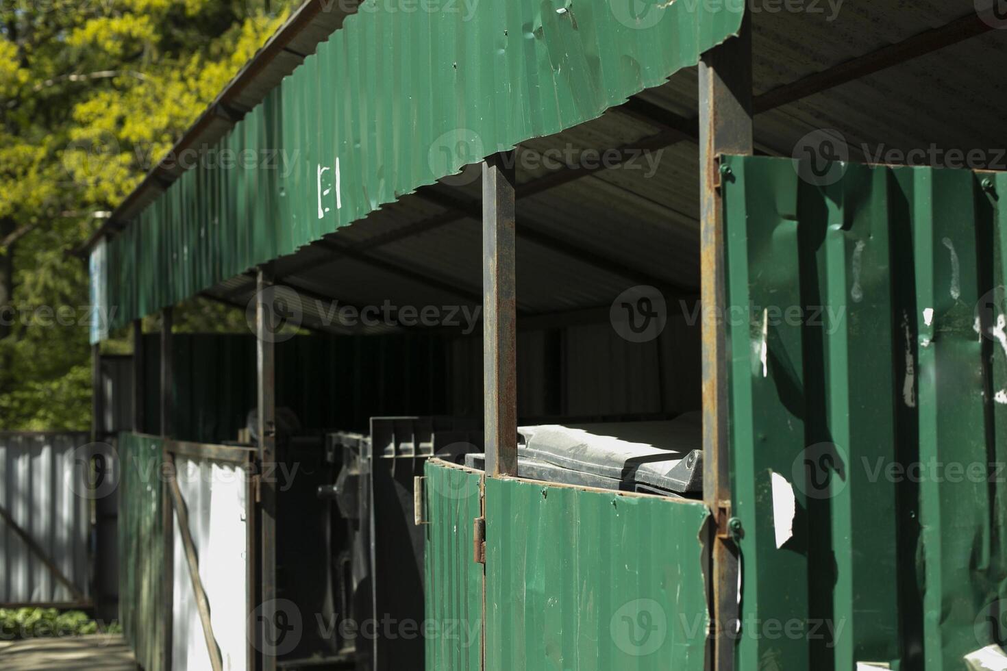 Garbage in city. Place to dispose of garbage. Steel structure for garbage cans. photo