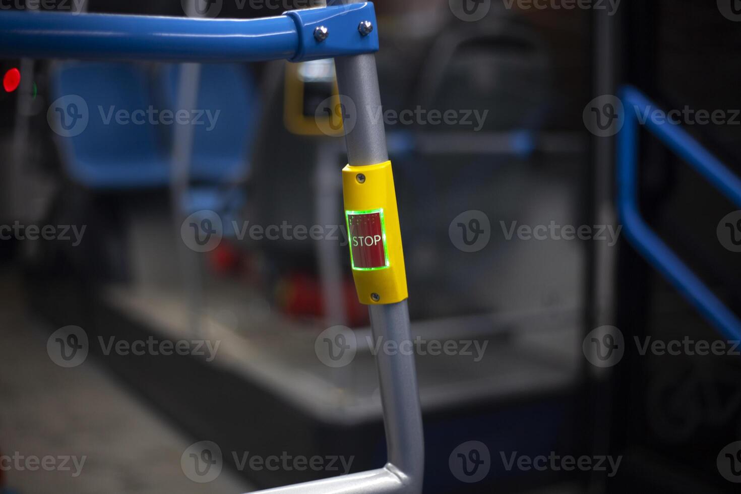 Stop button on the bus. Interior of public transport. Stop button on handrail. photo