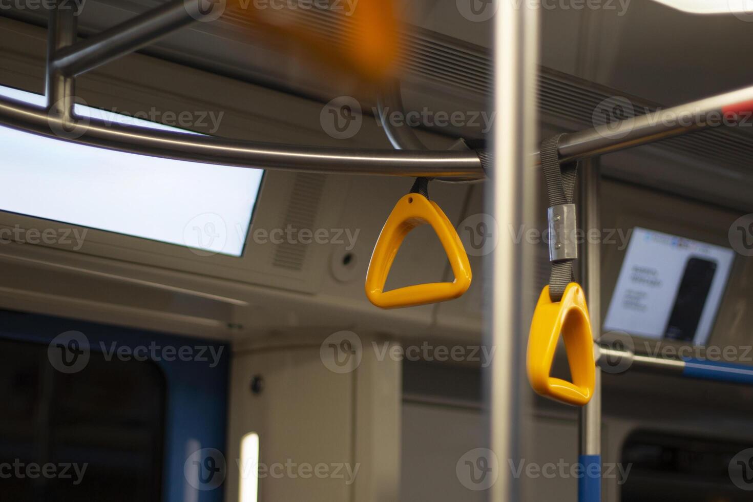 Handrail in the bus. Yellow hand handle. Passenger holder. photo