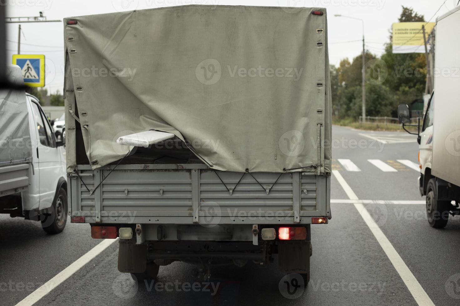 A truck is driving down the road. Freight. Roomy body. photo