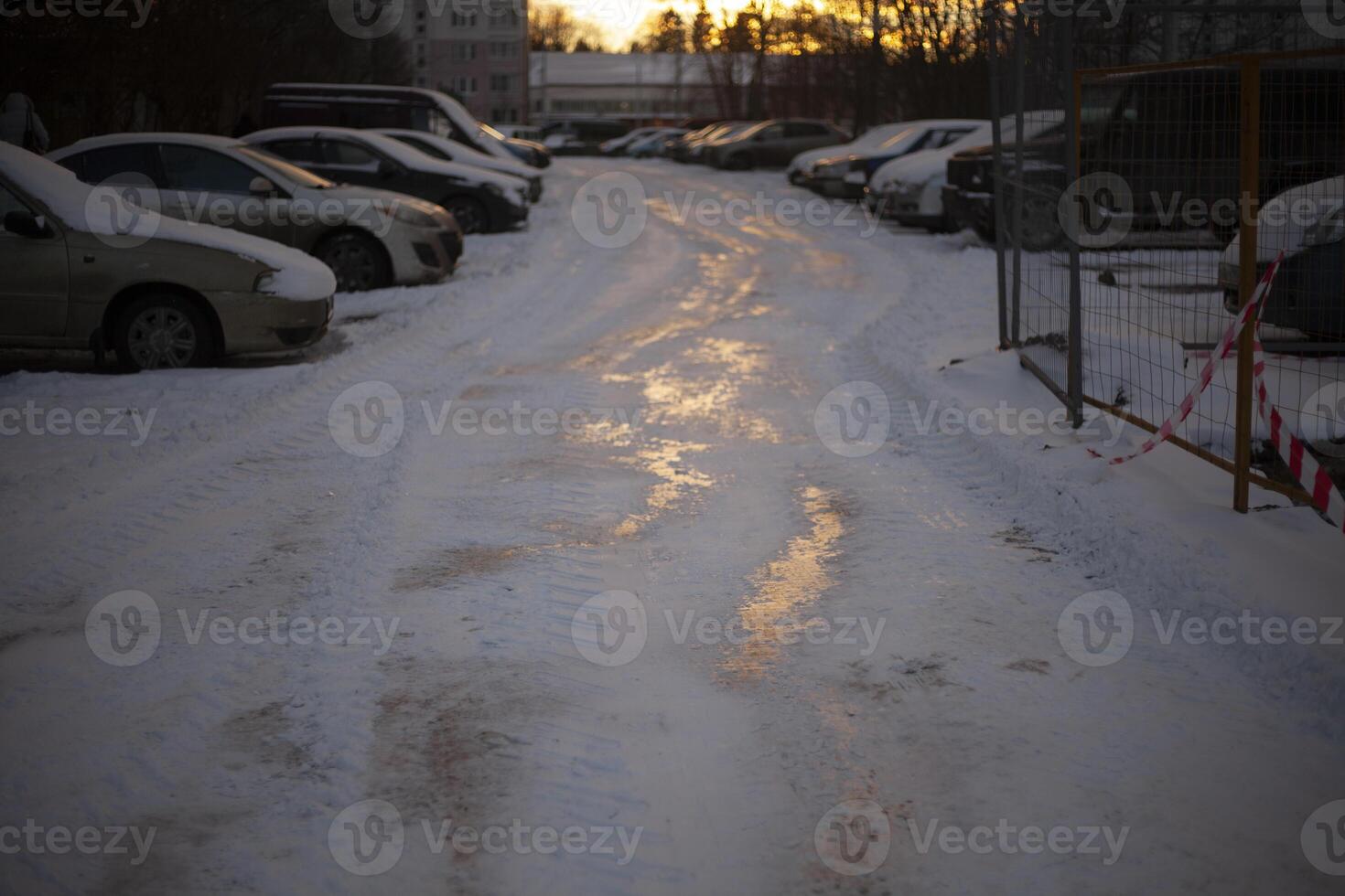 Parking in winter. Cars in parking lot in yard. Frozen road in city. Morning in parking lot. photo