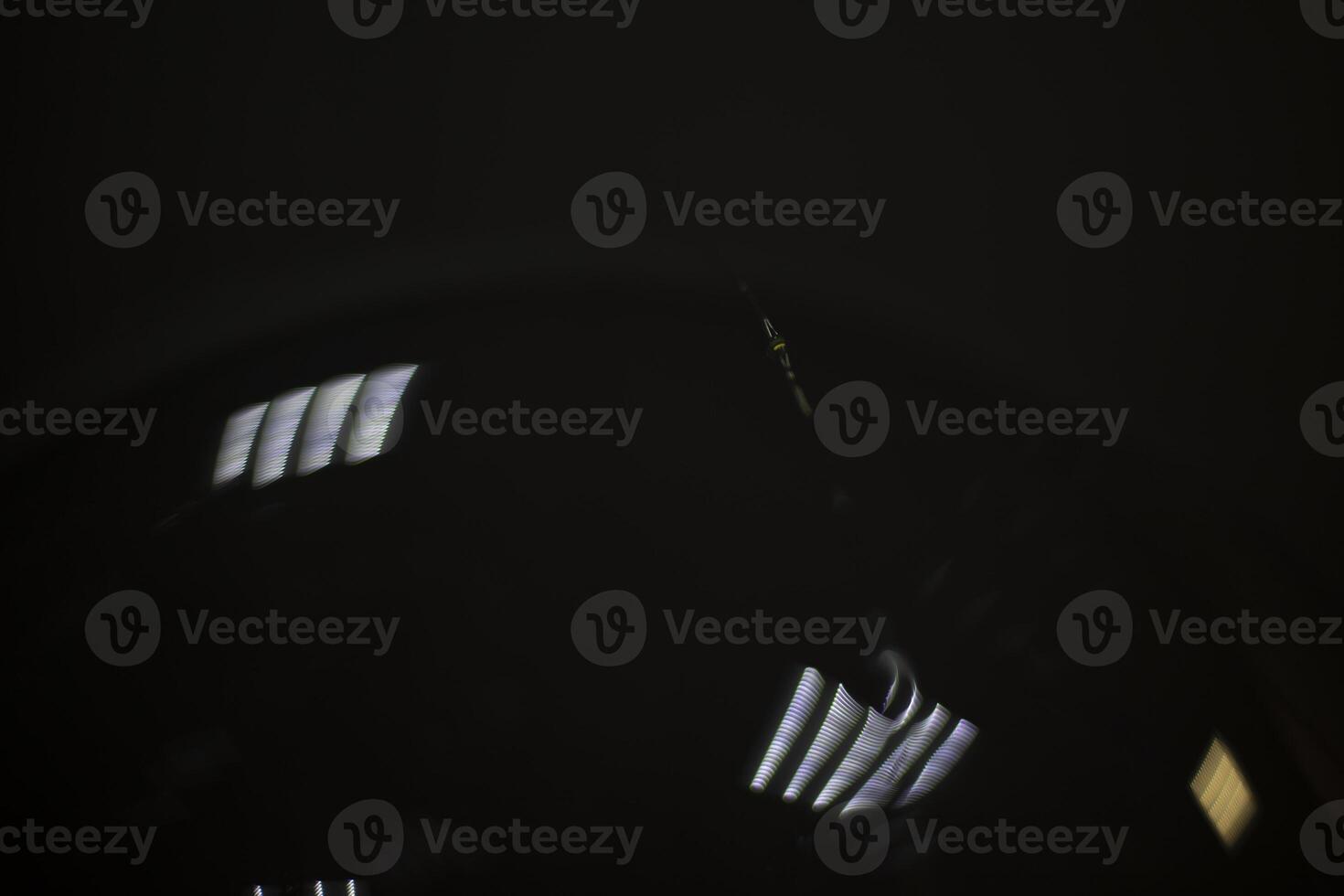 Weak light source. Transparent plastic on black background. photo