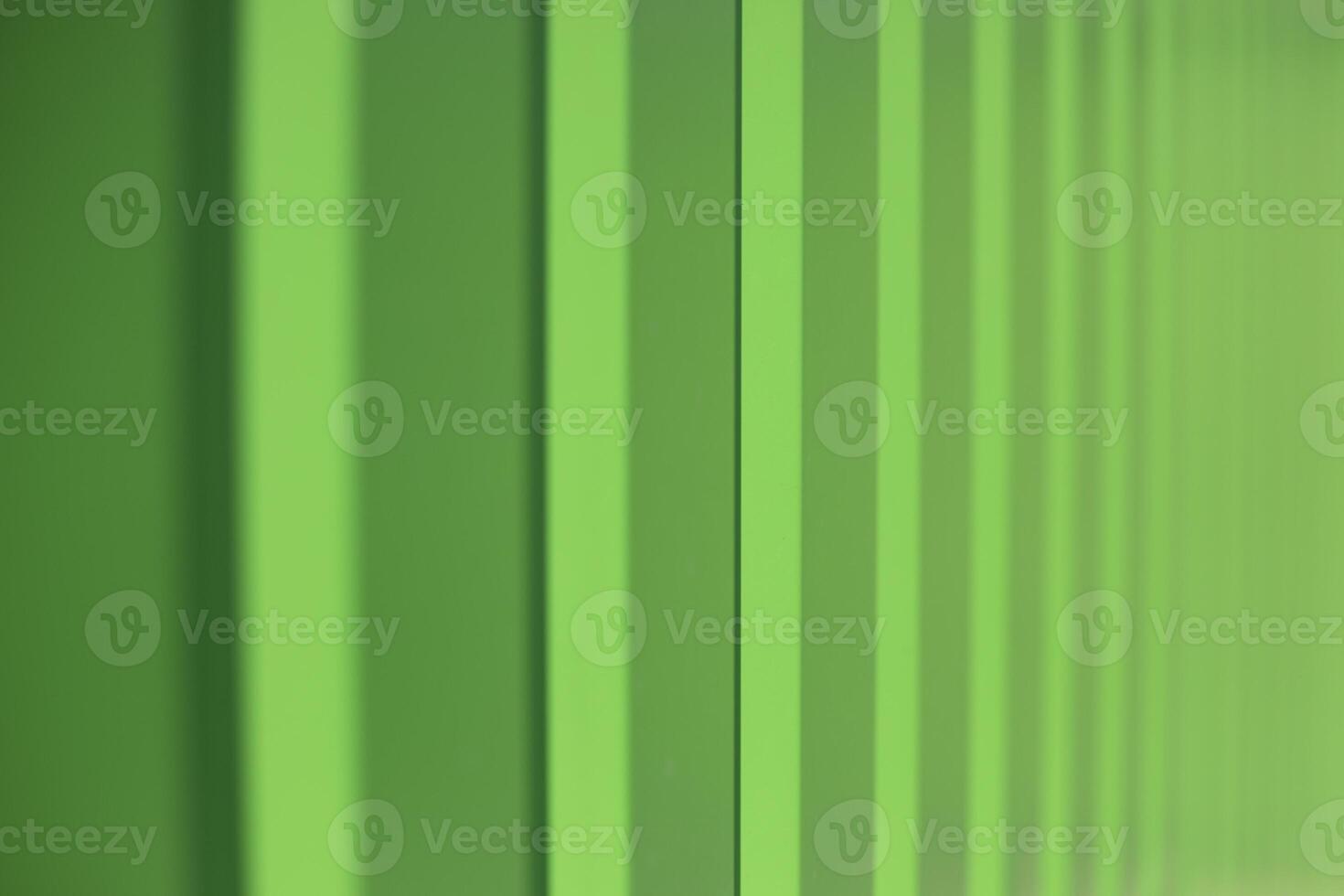 Green fence. Fence in detail. Ribbed steel. photo