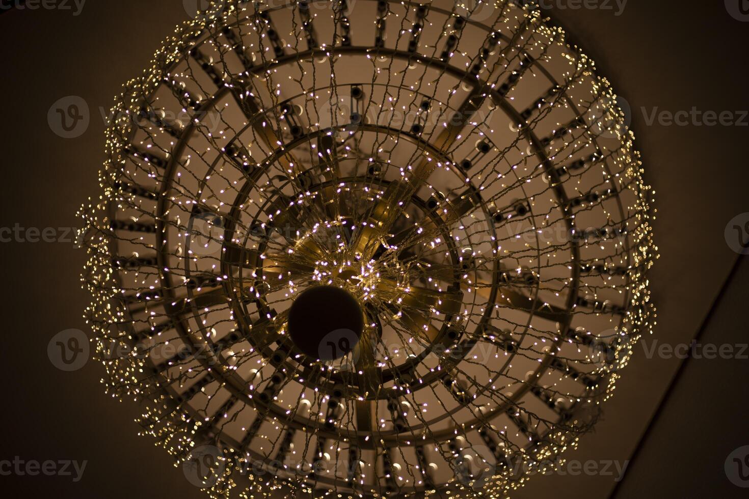The chandelier on the ceiling. Antique chandelier in the Great Hall. Vintage interior. photo