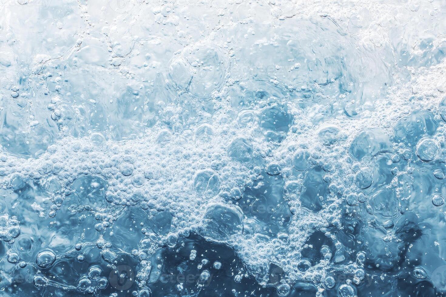 A close up of a wave with bubbles photo