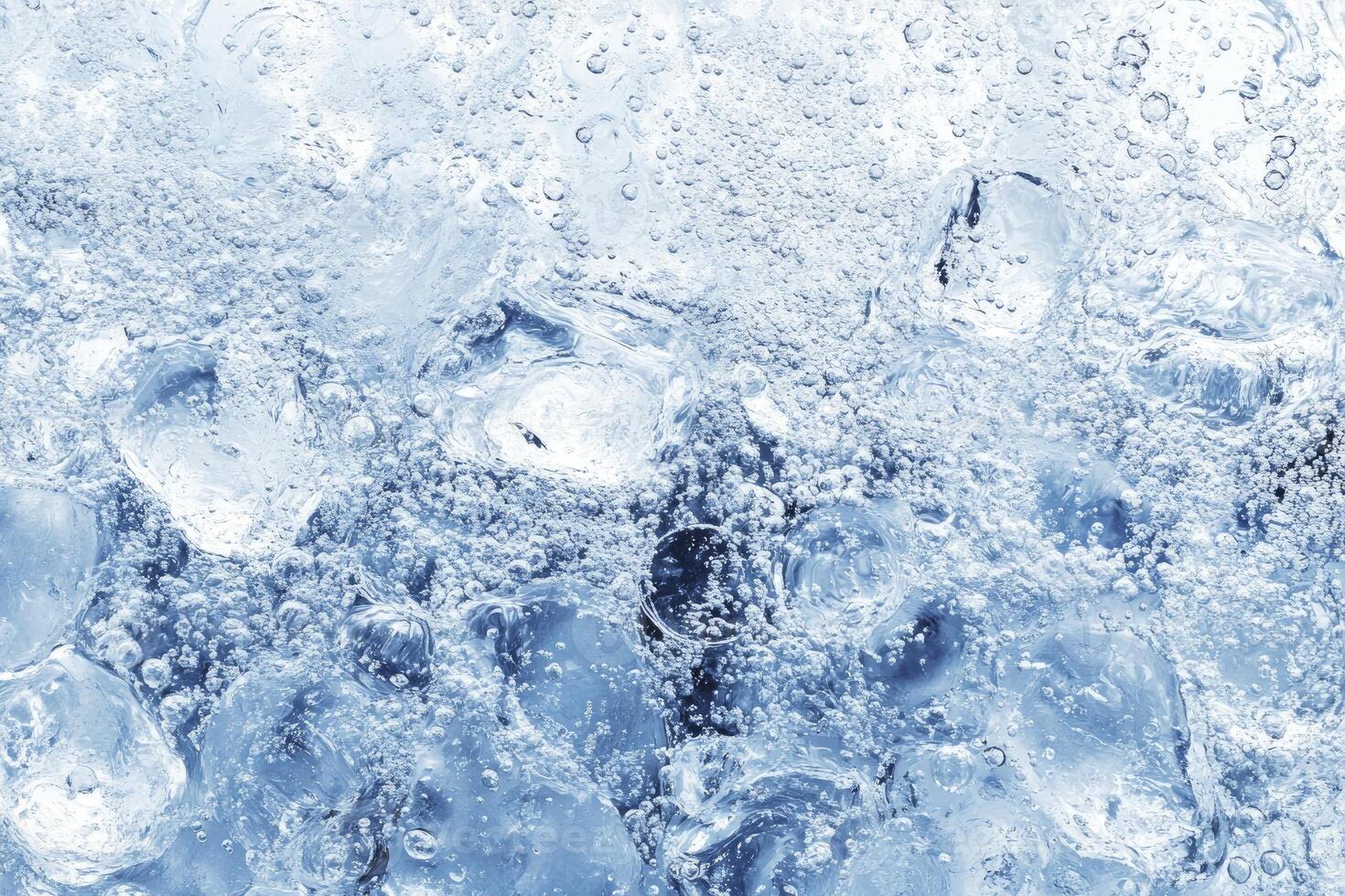 Ice water background with ice cubes photo