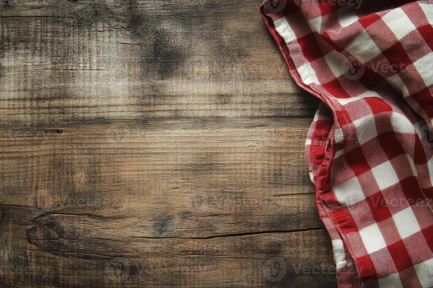 A red and white checkered cloth on a wooden table photo