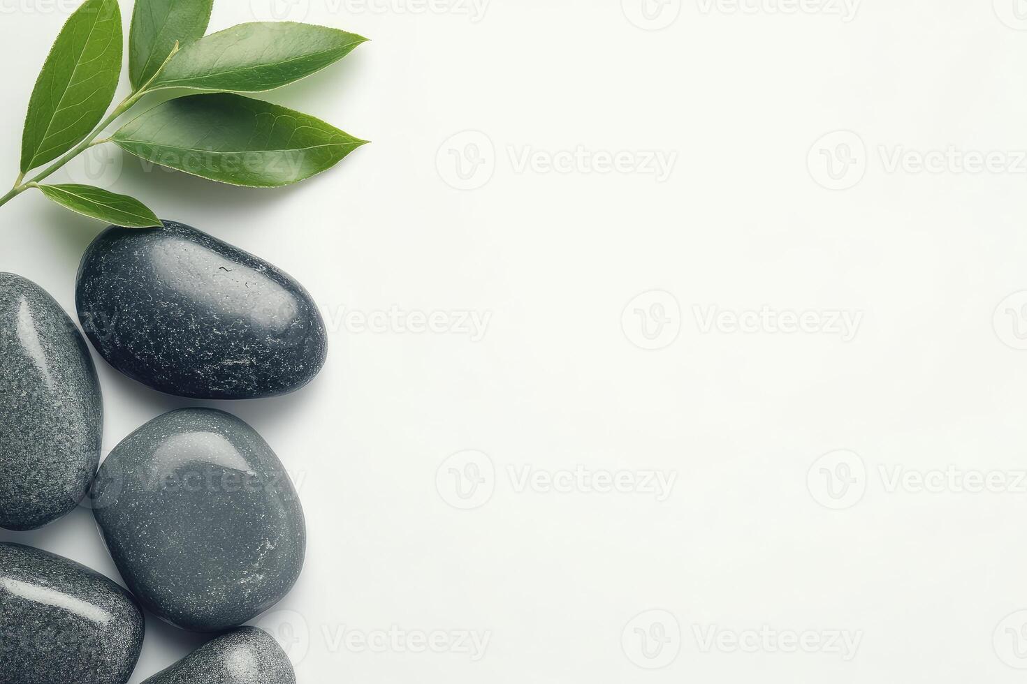 Spa stones and green leaves on white background photo