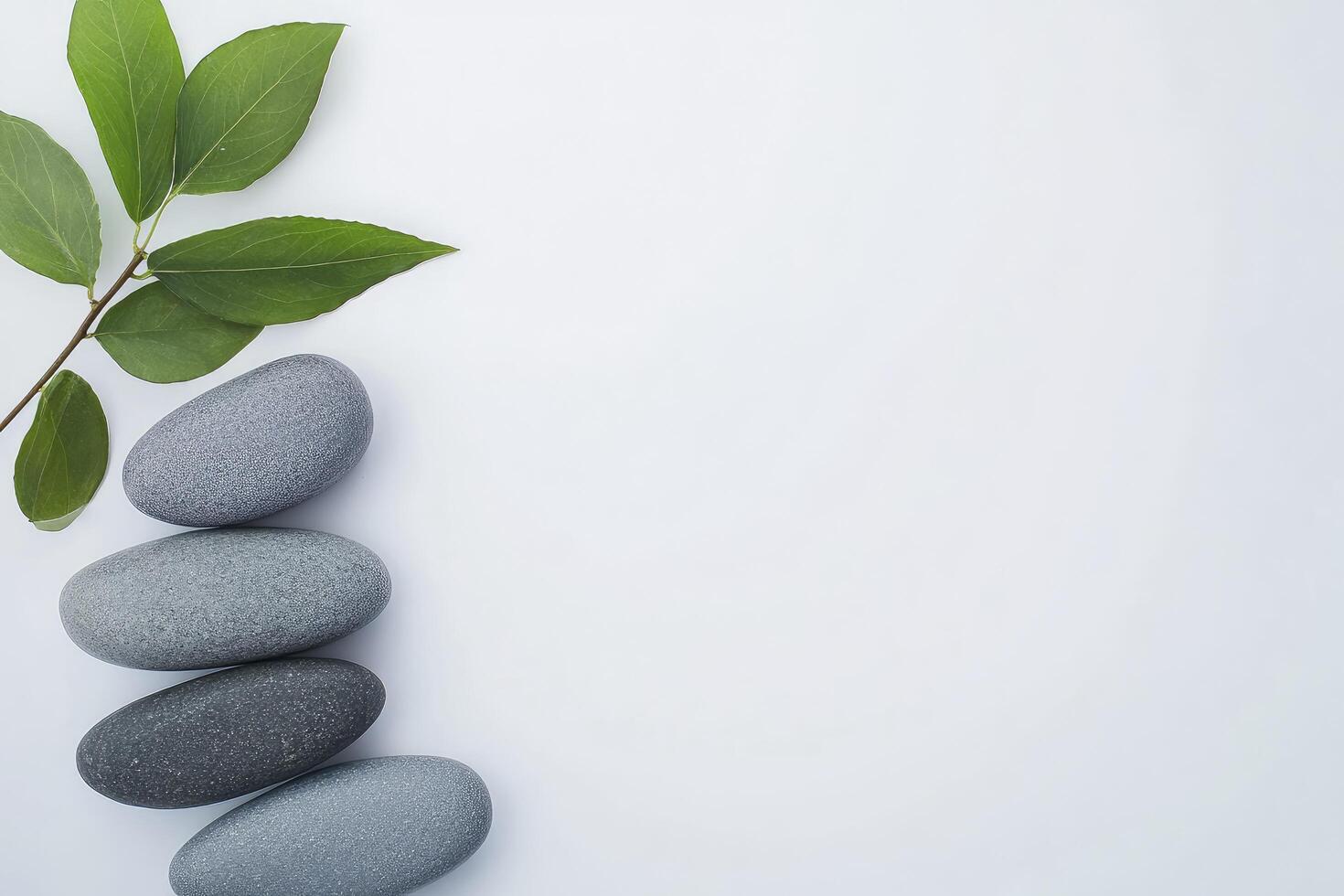 Three stones and a leaf on a white background photo