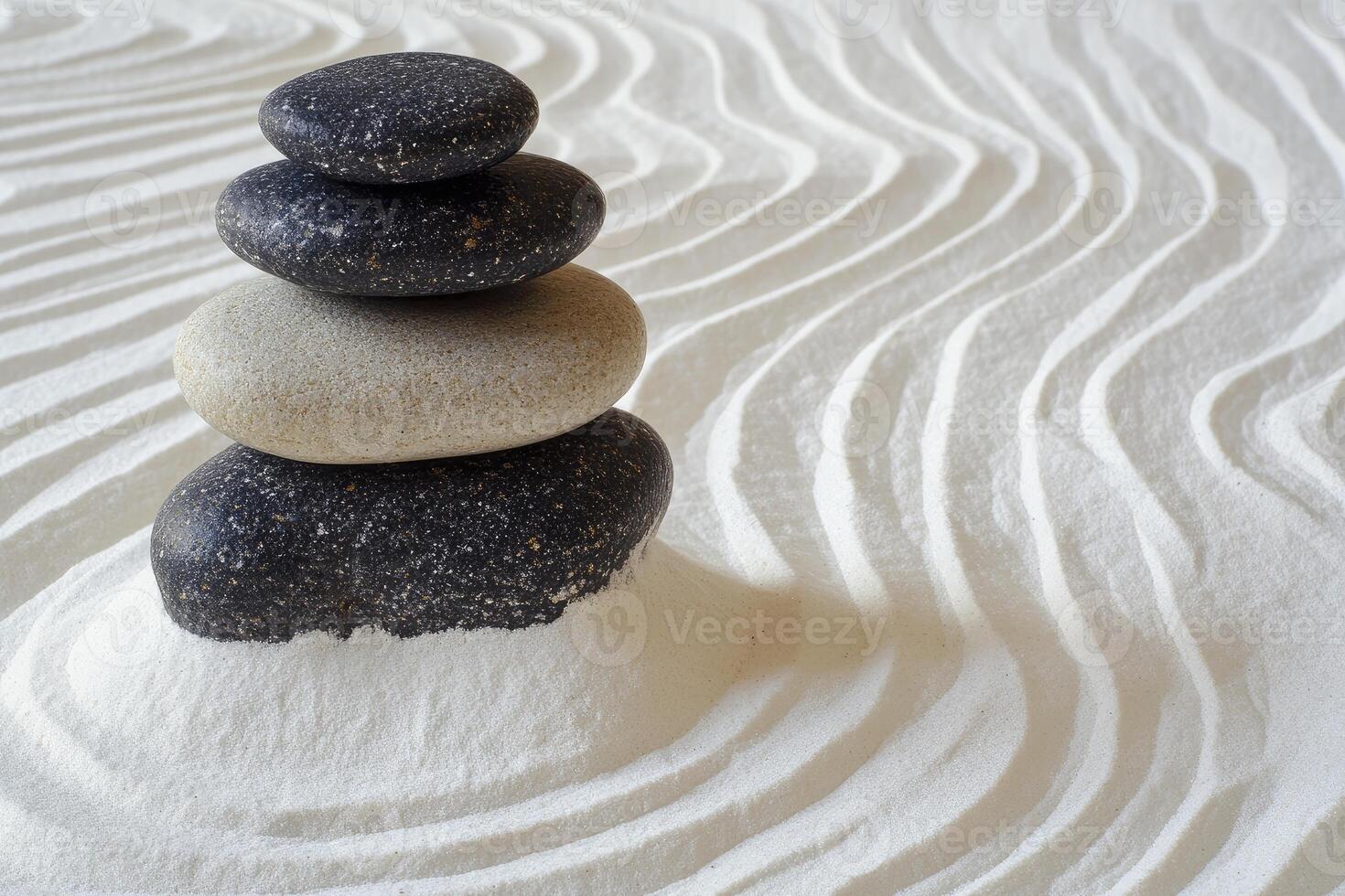 A stack of rocks sitting on top of a white sand photo