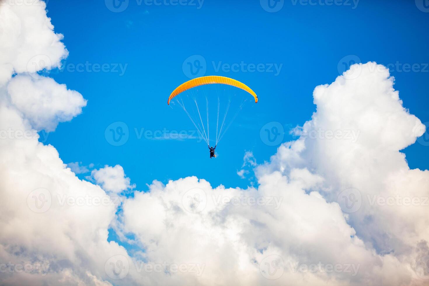 People paragliding over the beautiful mountains of the Antioquia department in Colombia. Tandem Paragliding. Extreme sport concept. photo