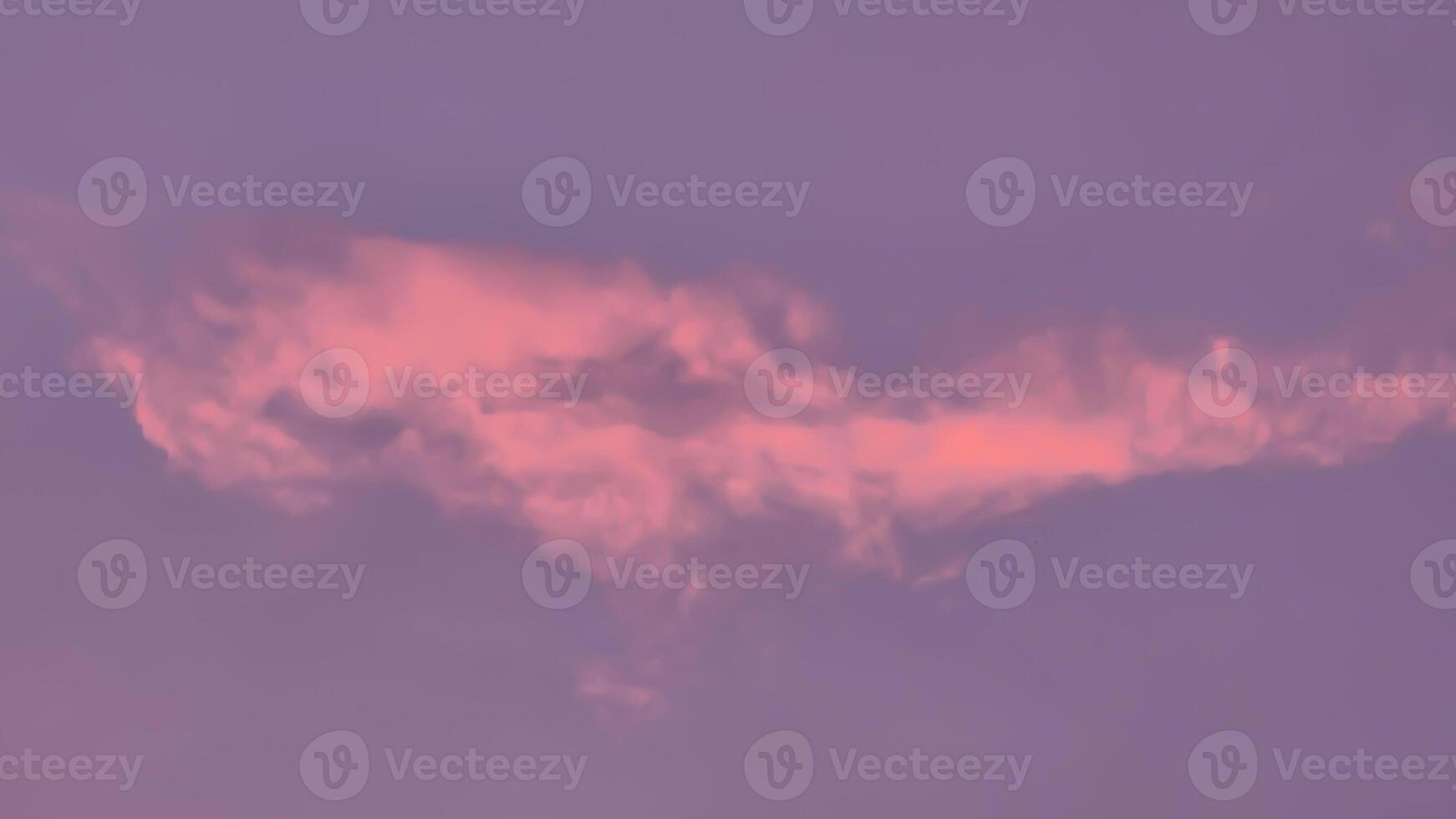 A pink cloud in the sky with a pink sky photo