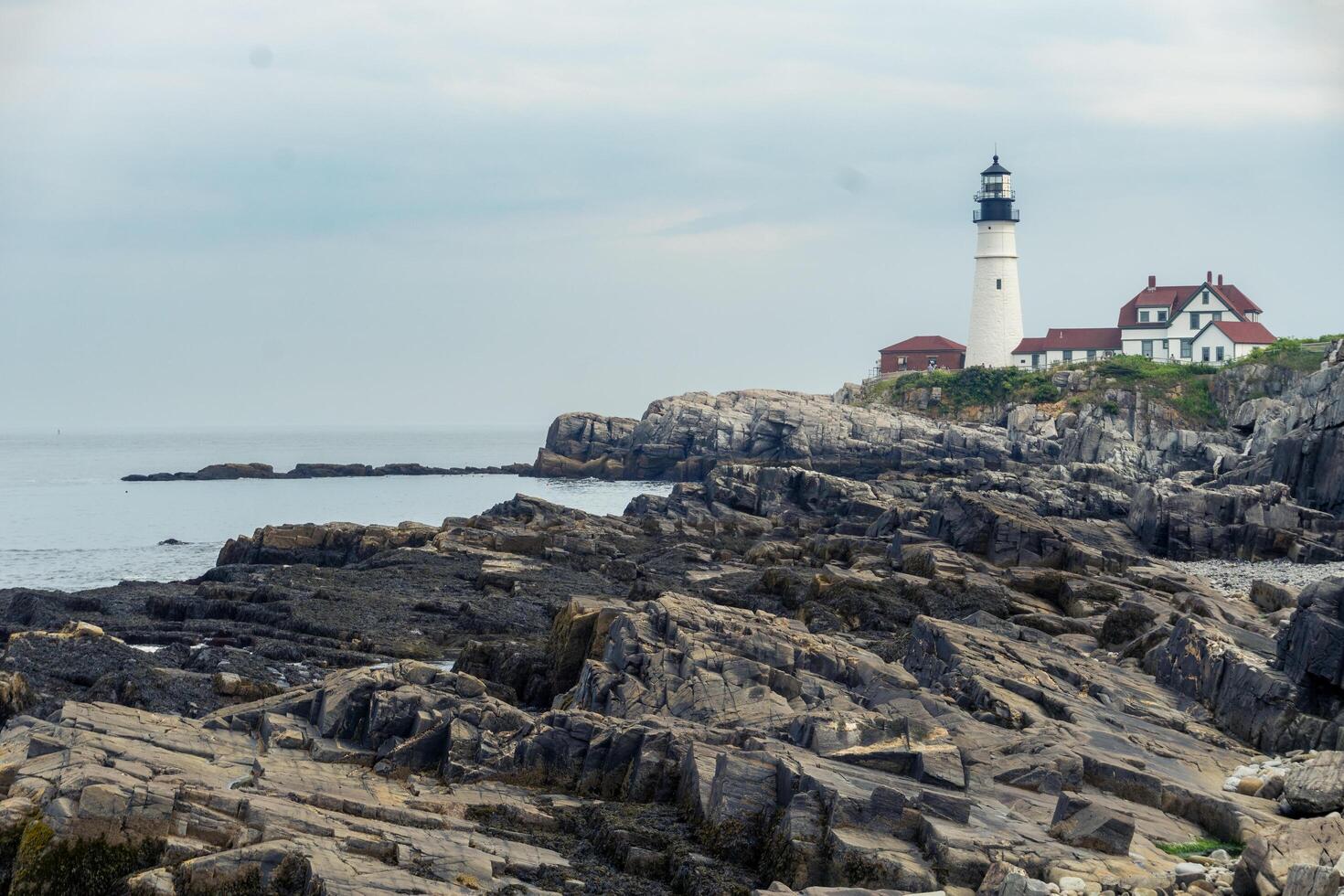 Portland, USA - August 13, 2019-view of the Portland Head Light a historic lighthouse in Cape Elizabeth, Maine during a cloudy day photo