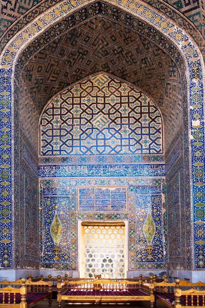Samarkand, Uzbekistan-august 12, 2023-walking inside the historic Madrasas in the Registan square during a sunny day photo