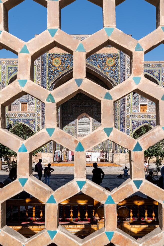 Samarkand, Uzbekistan-august 12, 2023-Shops inside the Madrase in the Registan square during a sunny day photo