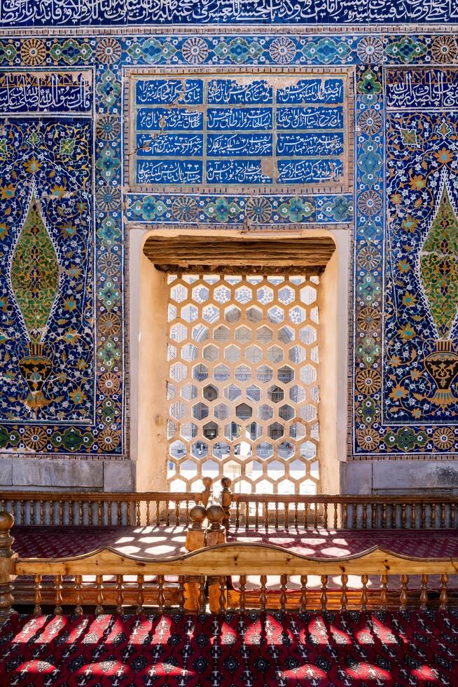 Samarkand, Uzbekistan-august 12, 2023-walking inside the historic Madrasas in the Registan square during a sunny day photo