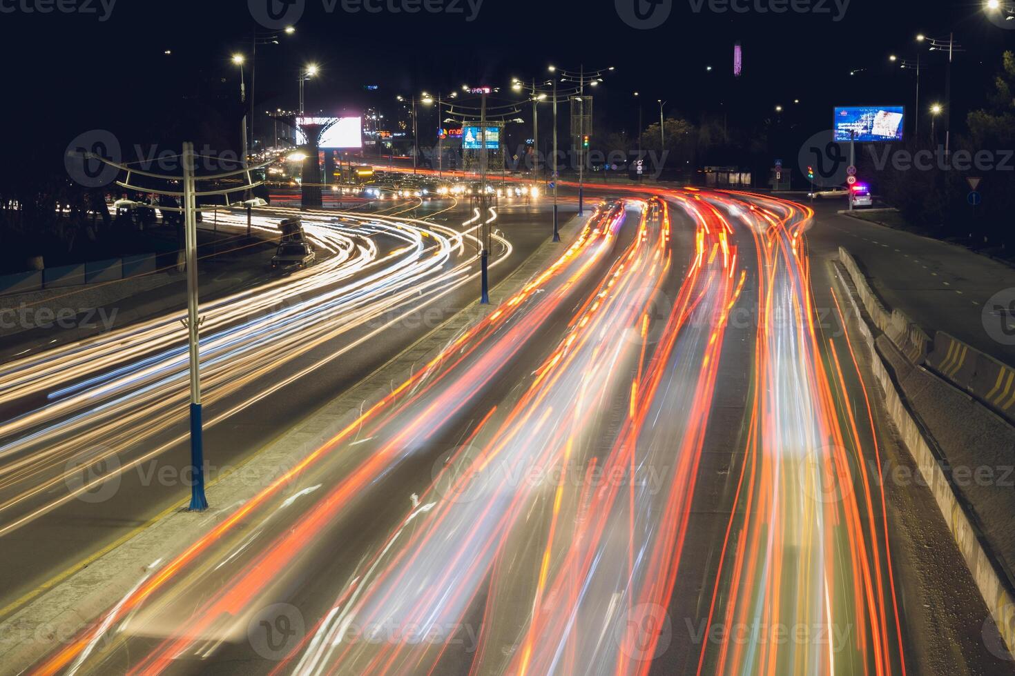 City road background with automobile light trails blurred headlights in the evening photo