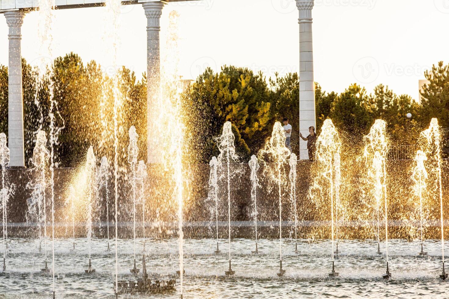 Water fountain with splashes of water for relaxation and coolness of the city and parks photo