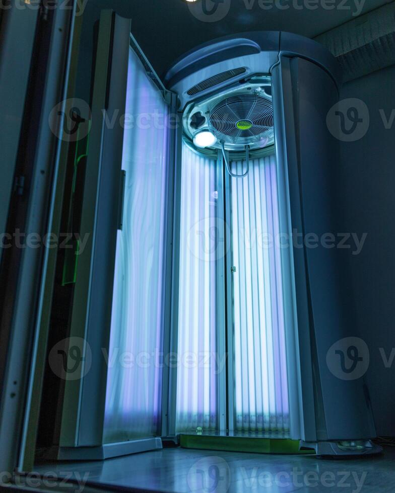 Standing empty solarium with blue light photo