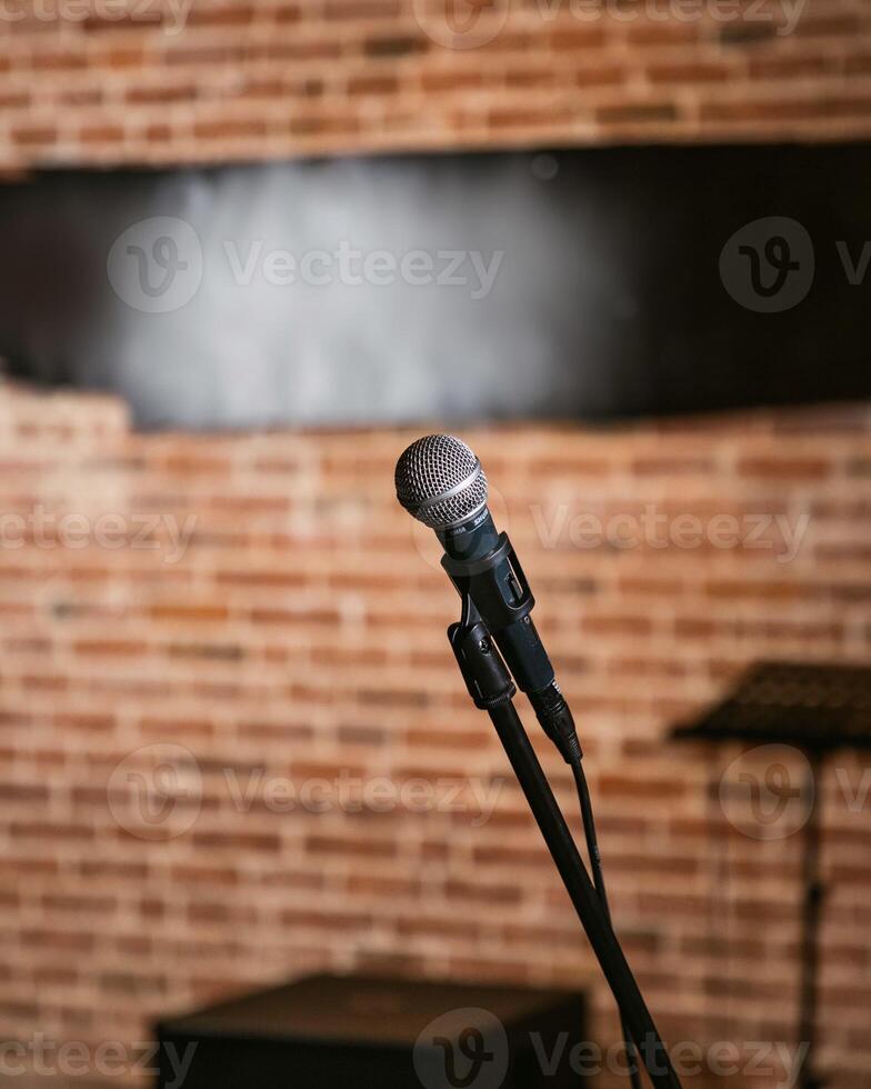 Microphone standing on stage with brick wall background photo