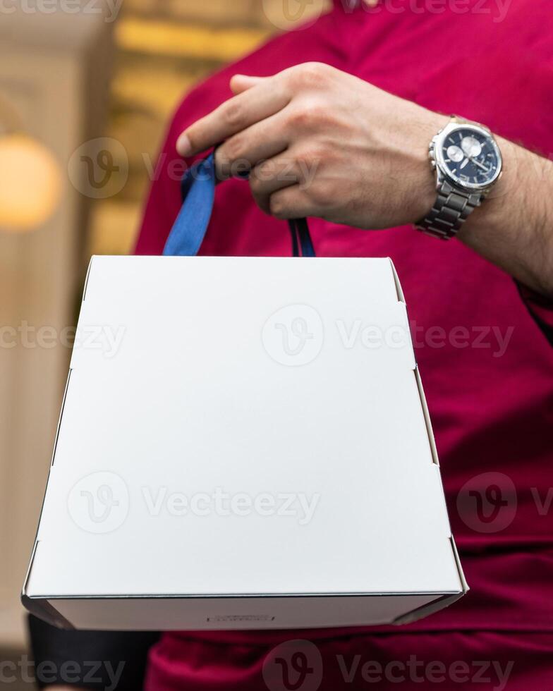 Man holding white box photo
