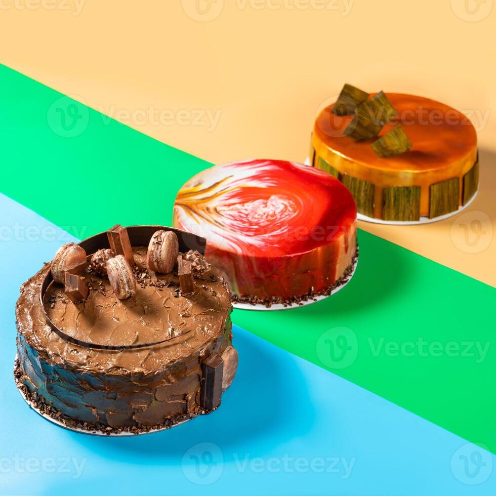 Different beautiful macaron, honey, jam cakes on the colorful background photo