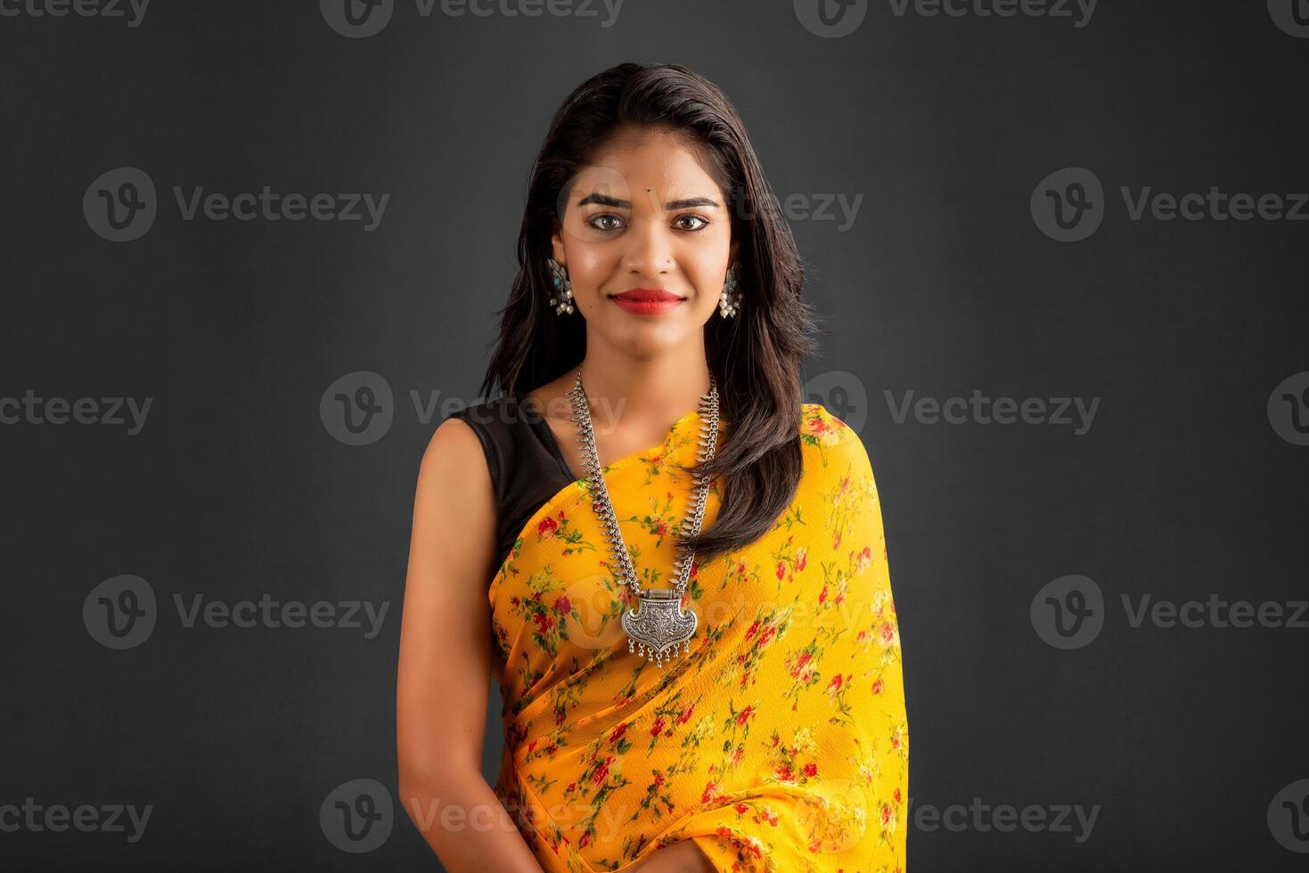 Portrait of a young girl or woman posing on gray background photo