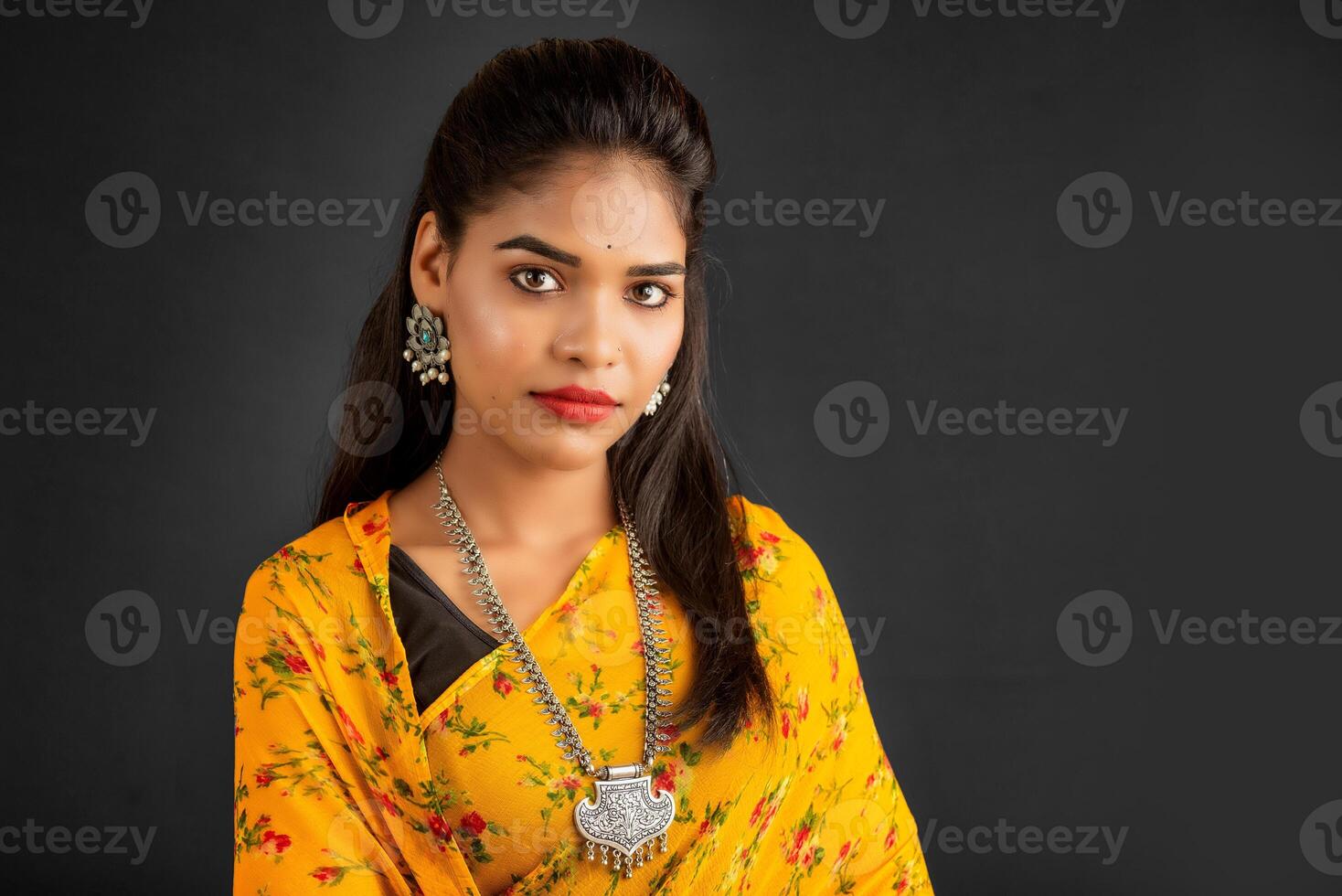 Portrait of a young girl or woman posing on gray background photo