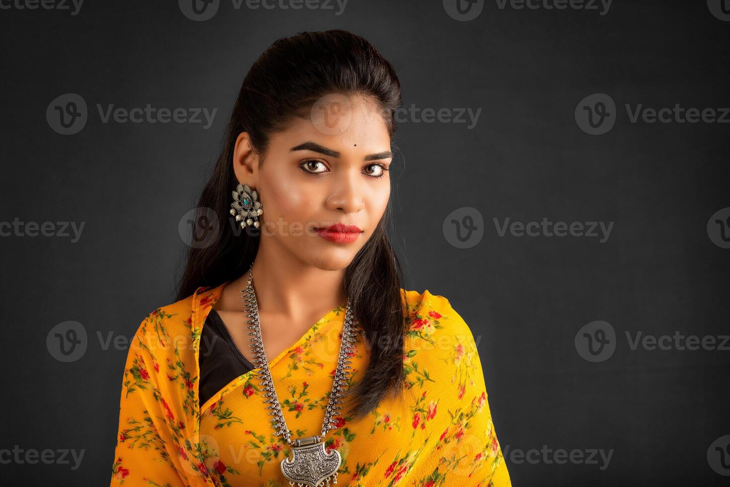 Portrait of a young girl or woman posing on gray background photo
