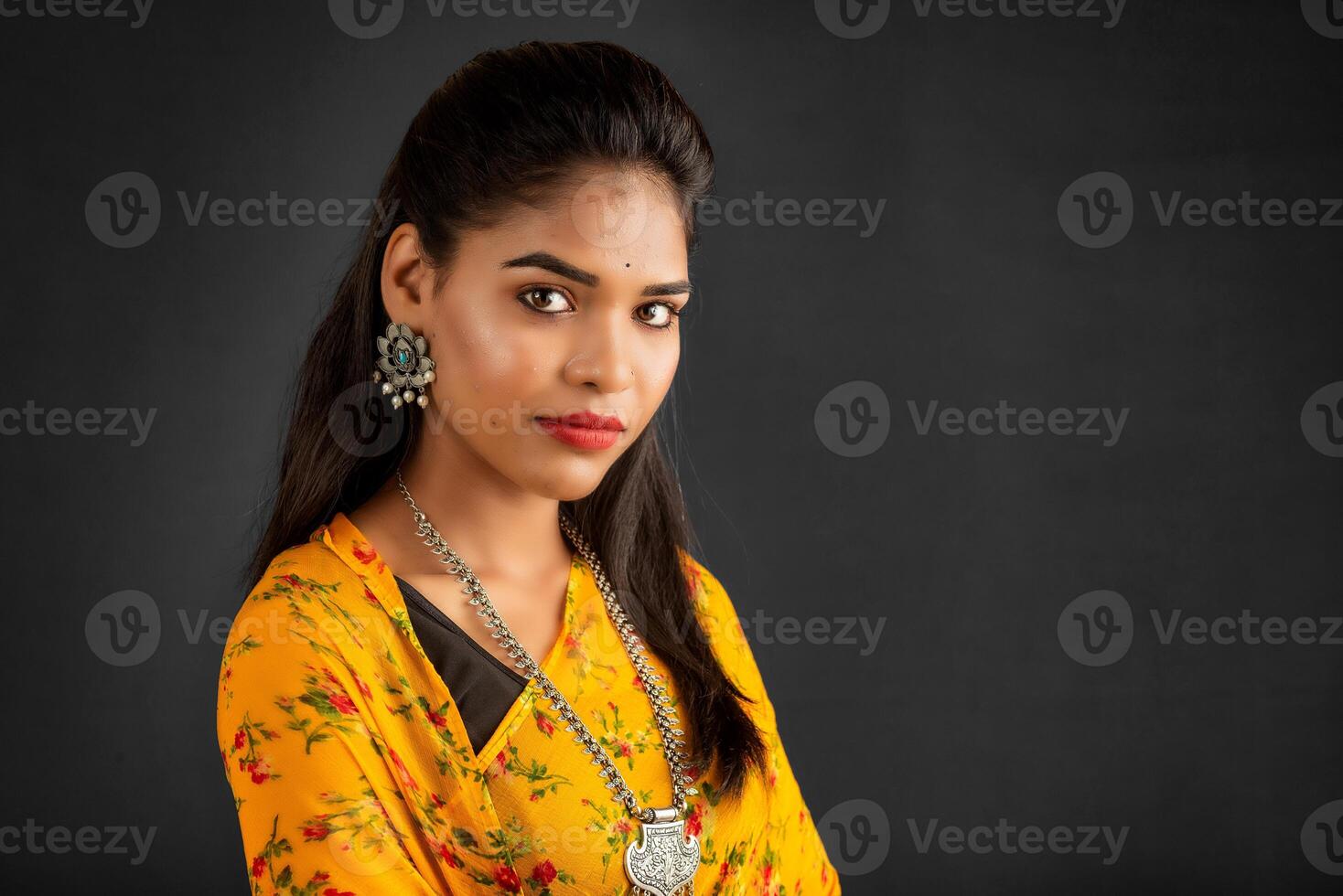 Portrait of a young girl or woman posing on gray background photo