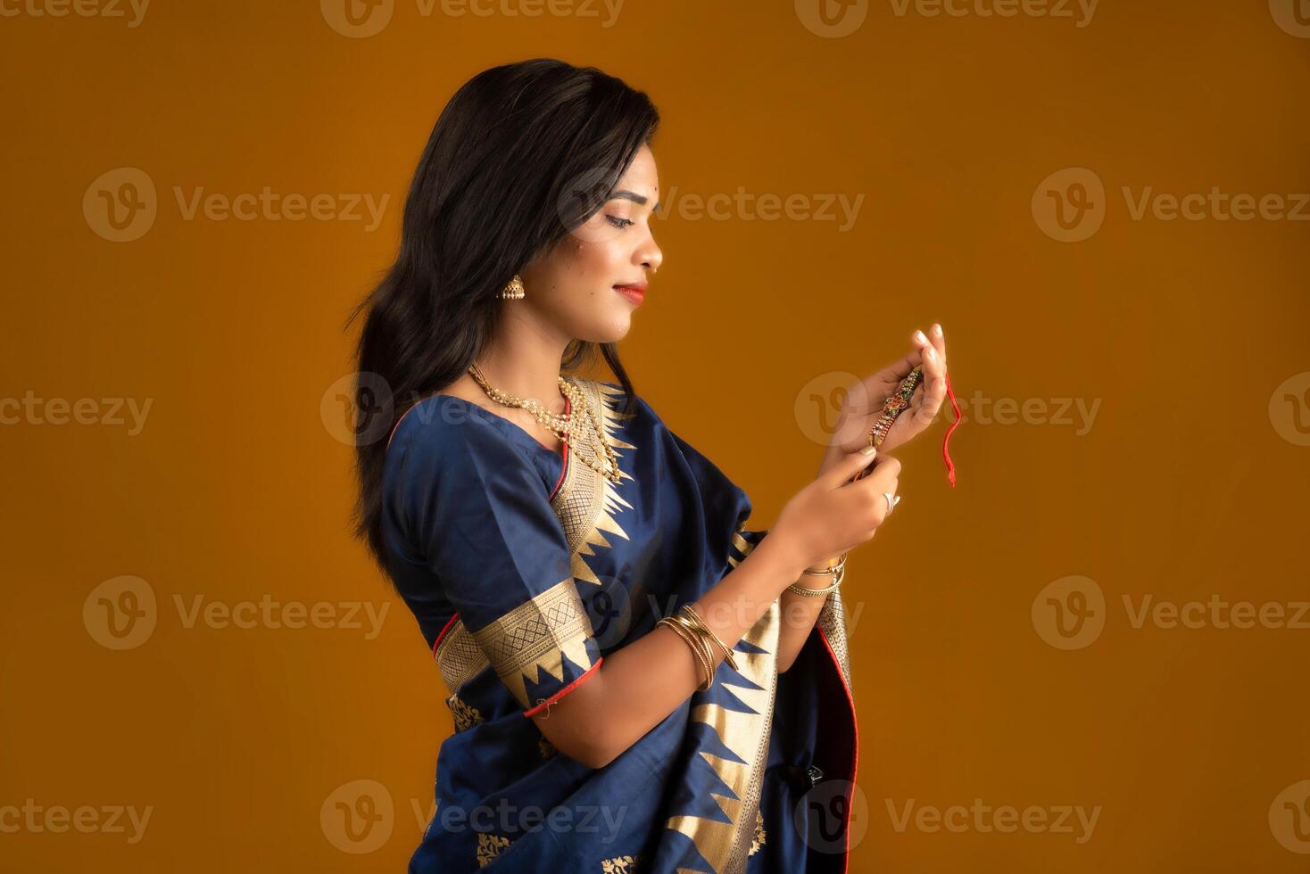 Beautiful Indian girl showing Rakhis on the occasion of Raksha Bandhan. photo