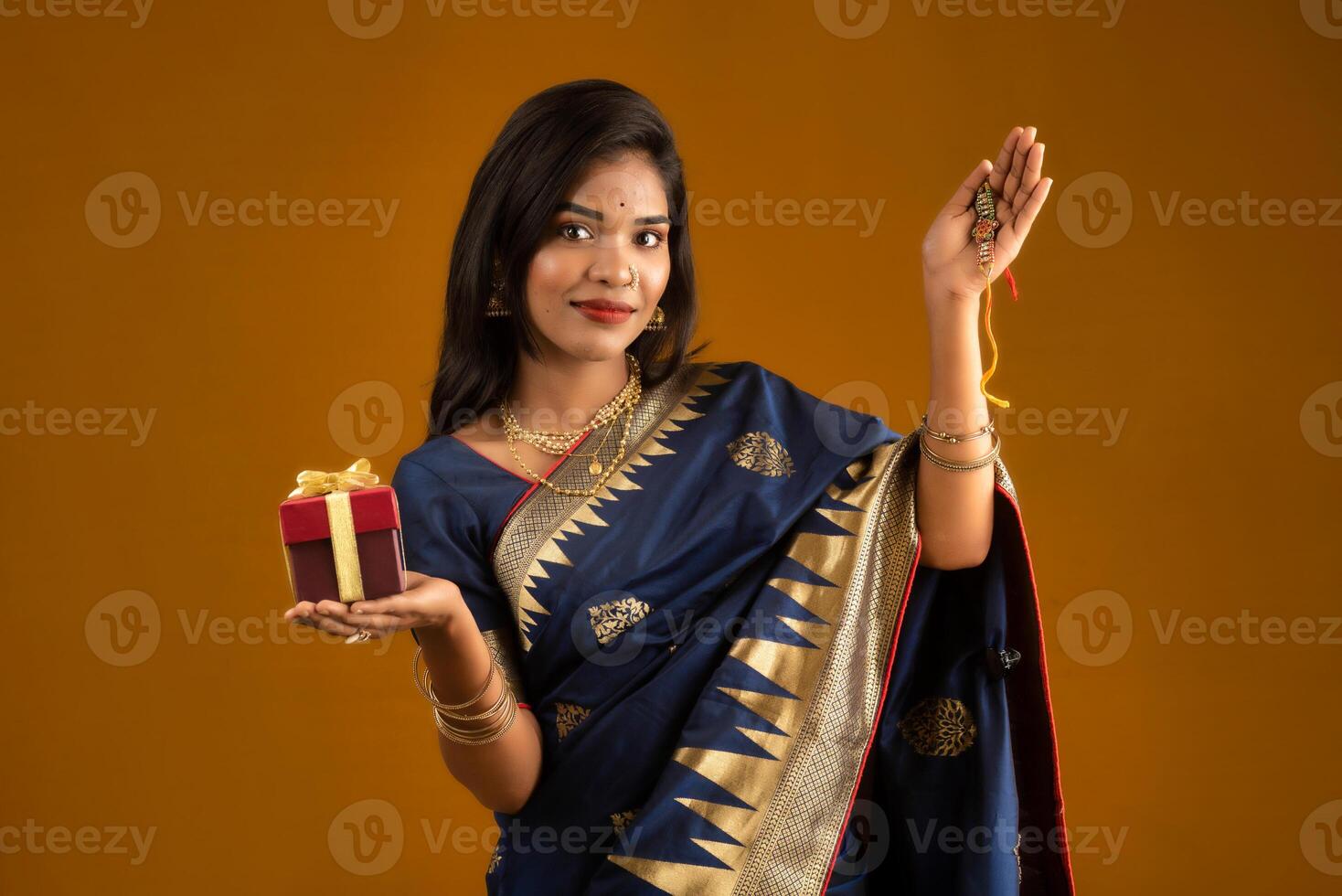 Beautiful Indian girl showing Rakhis and the gift box on the occasion of Raksha Bandhan. photo