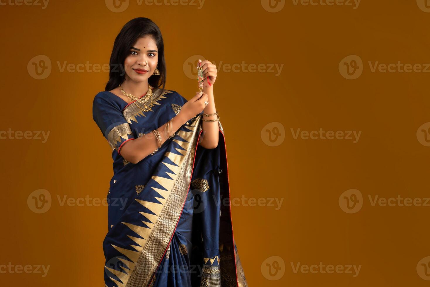 Beautiful Indian girl showing Rakhis on the occasion of Raksha Bandhan. photo