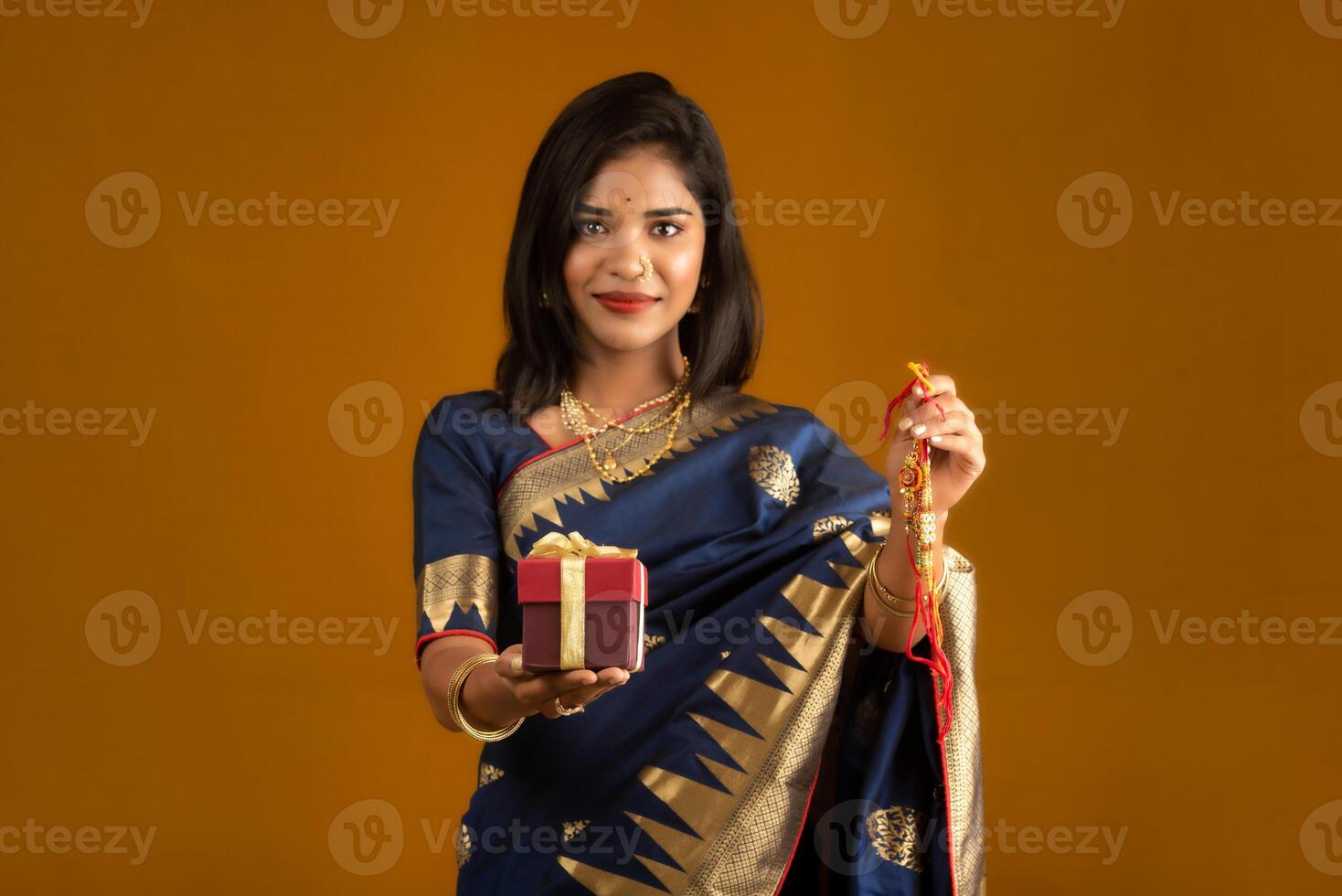 Beautiful Indian girl showing Rakhis and the gift box on the occasion of Raksha Bandhan. photo
