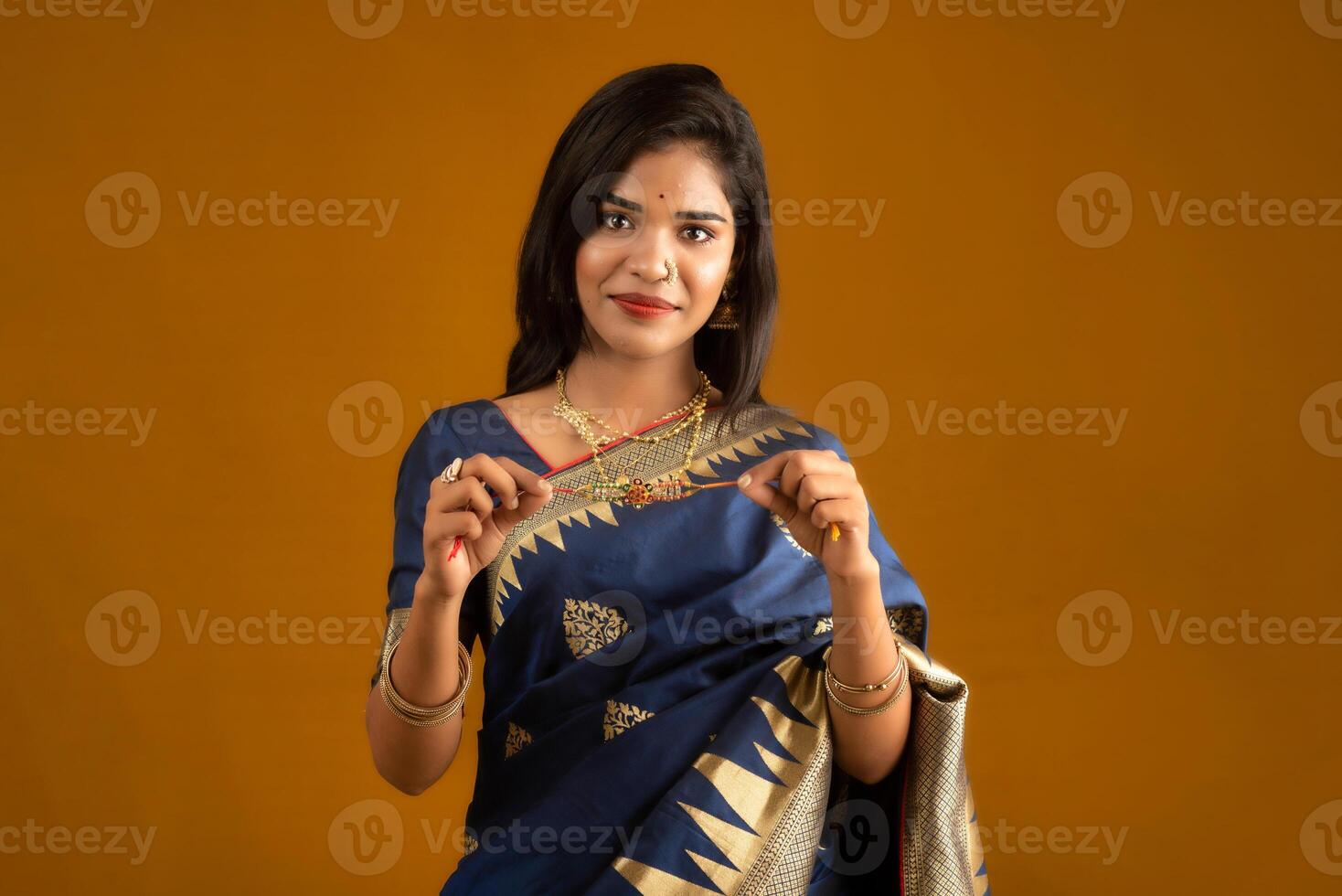 Beautiful Indian girl showing Rakhis on the occasion of Raksha Bandhan. photo
