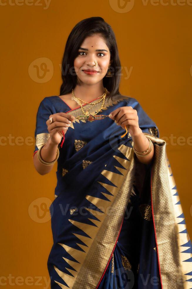 Beautiful Indian girl showing Rakhis on the occasion of Raksha Bandhan. photo