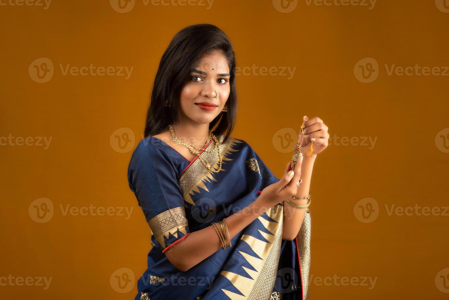 Beautiful Indian girl showing Rakhis on the occasion of Raksha Bandhan. photo
