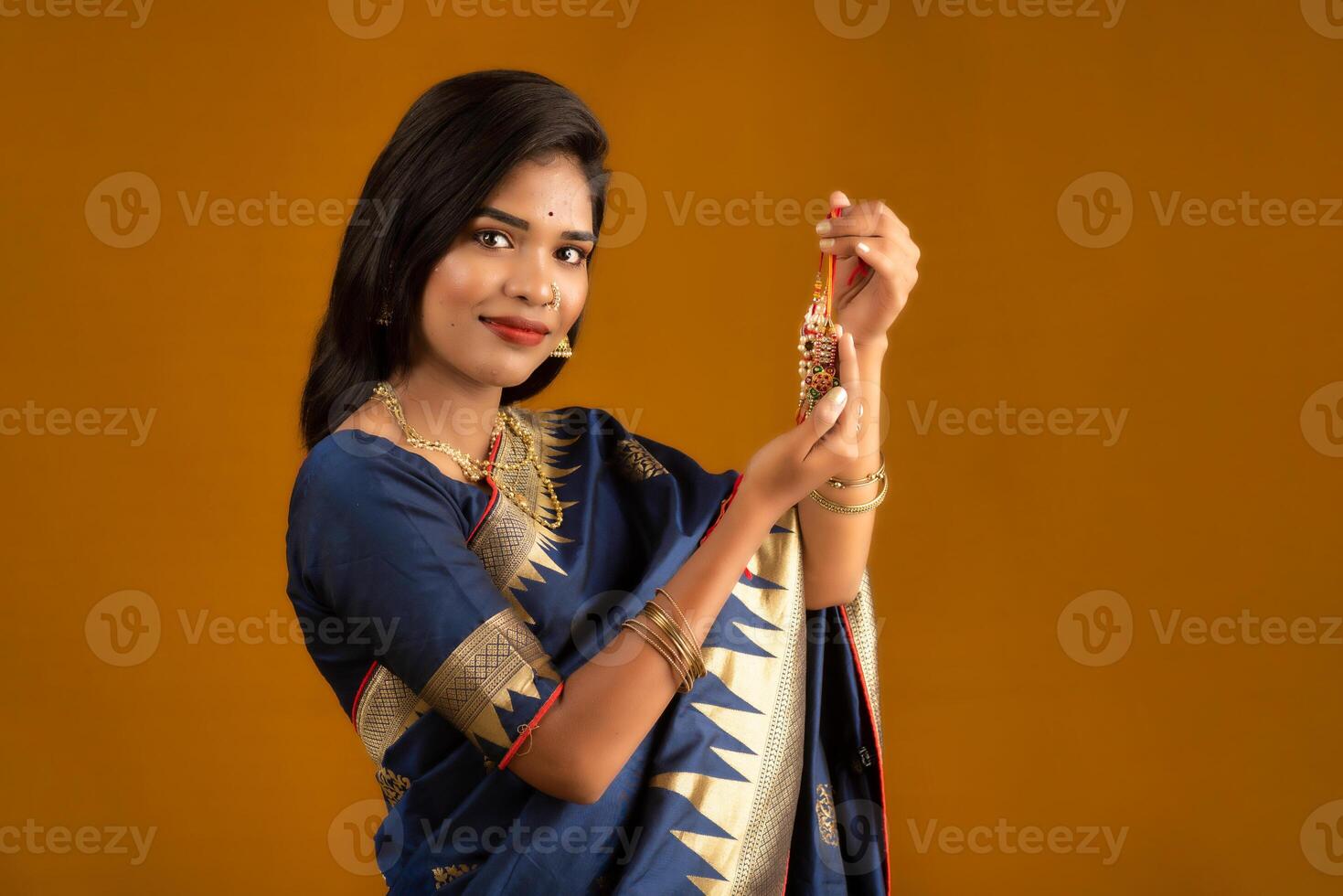 Beautiful Indian girl showing Rakhis on the occasion of Raksha Bandhan. photo